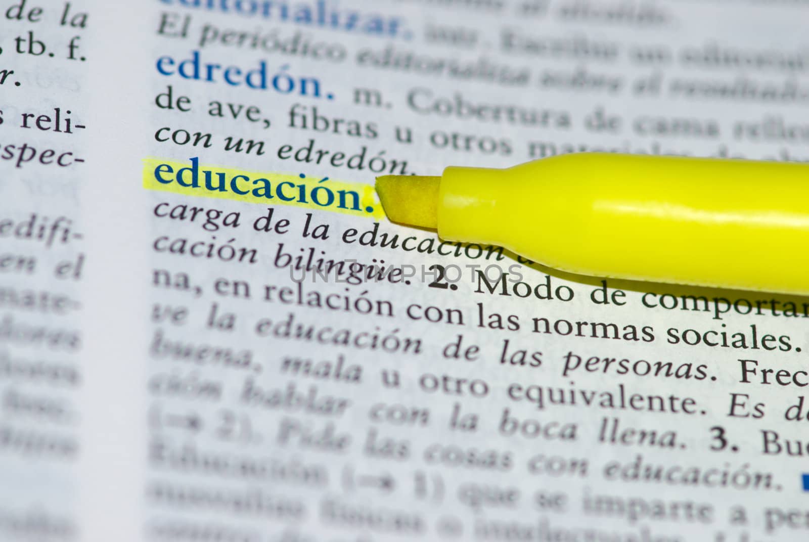 Spanish dictionary definition of the word education with focus on education and a hallow field depth.