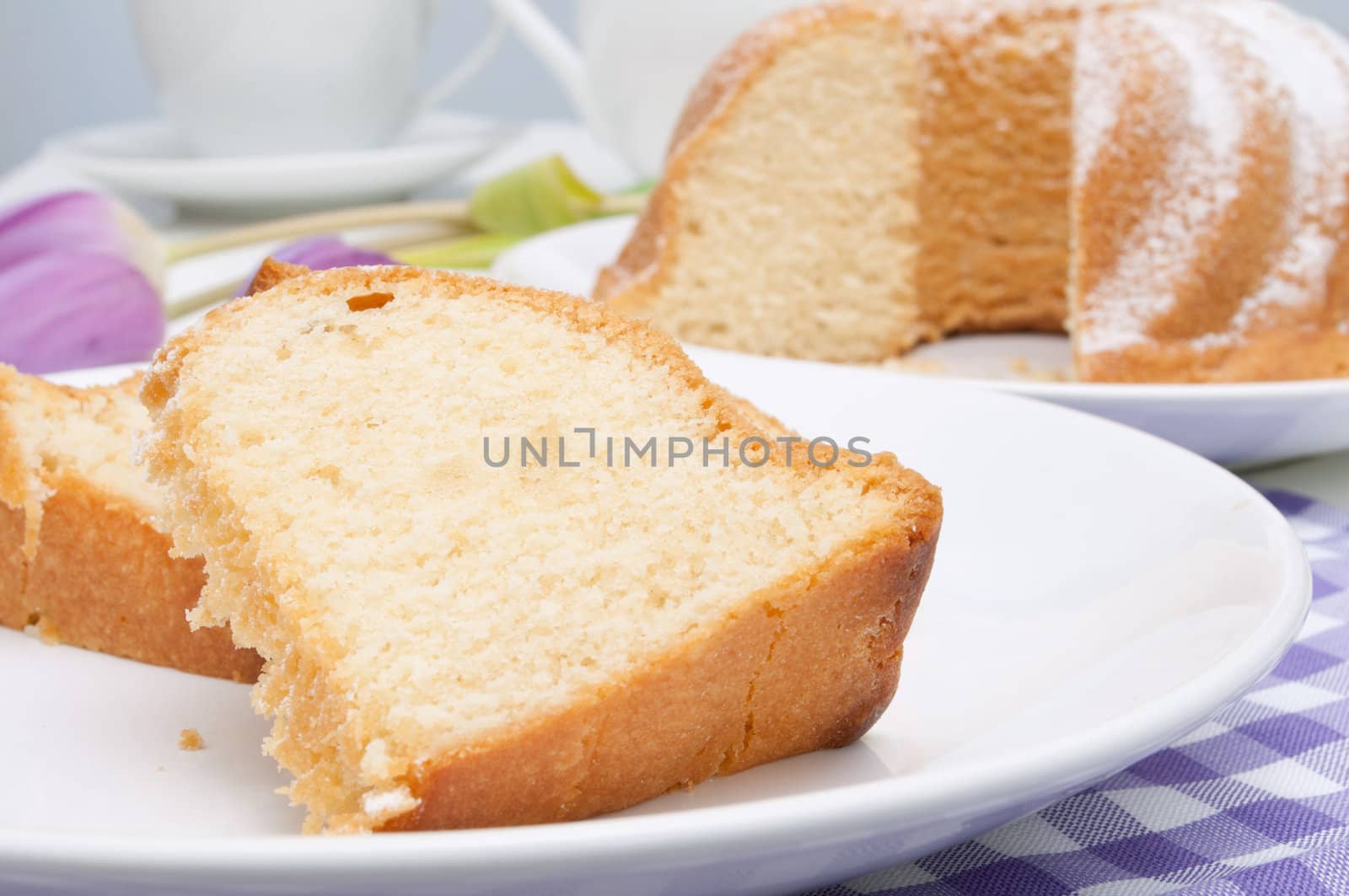 Guglhupf - Slices of Traditional Gugelhupf Sponge Cake and Tulip Flowers on Table