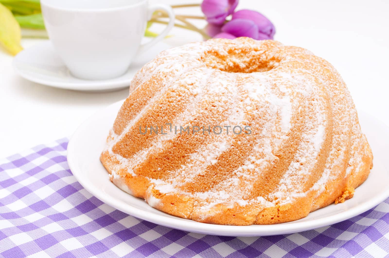 Guglhupf - Traditional Gugelhupf Sponge Cake and Tulip Flowers on Table