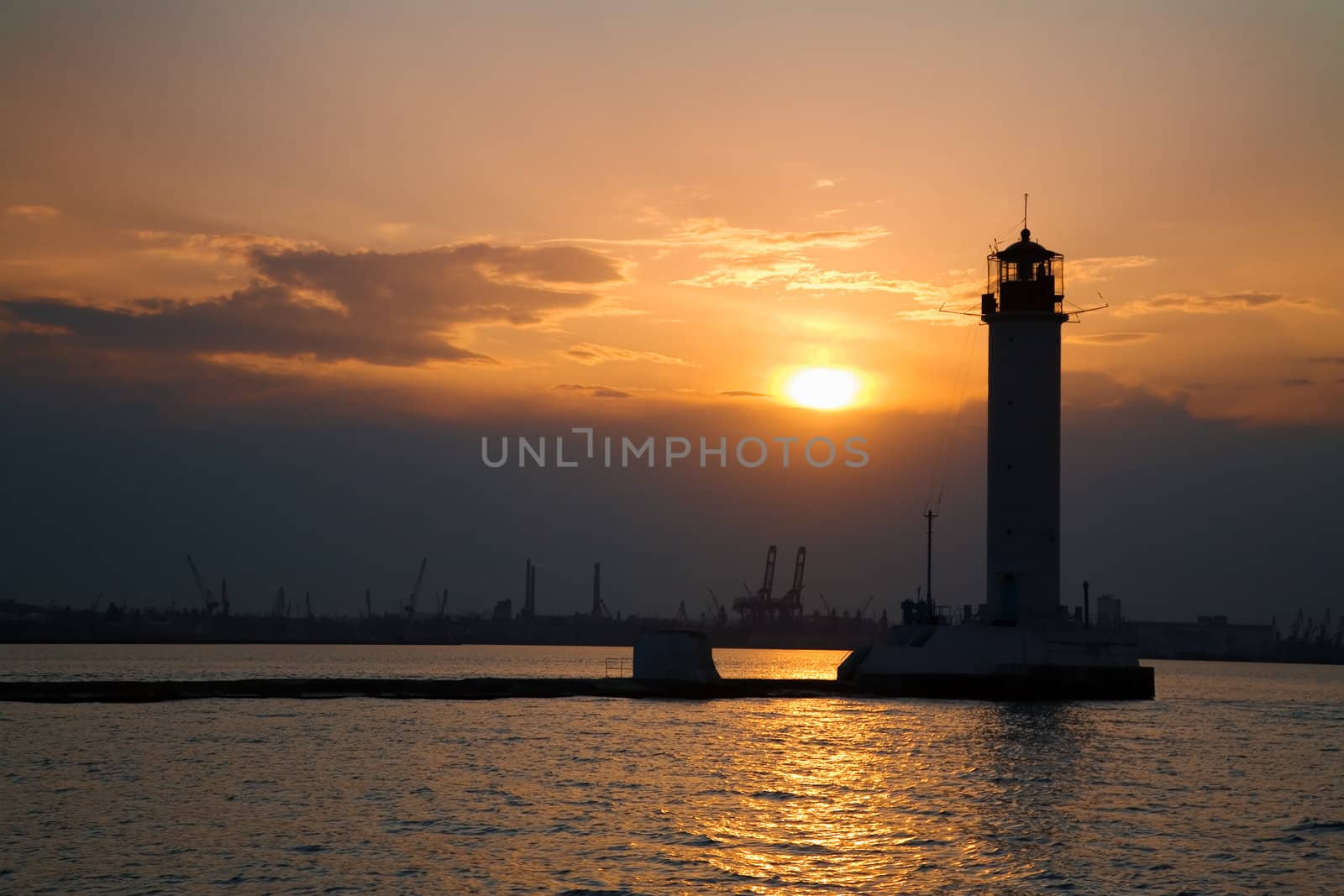 Silhouette of a lighthouse at dusk 