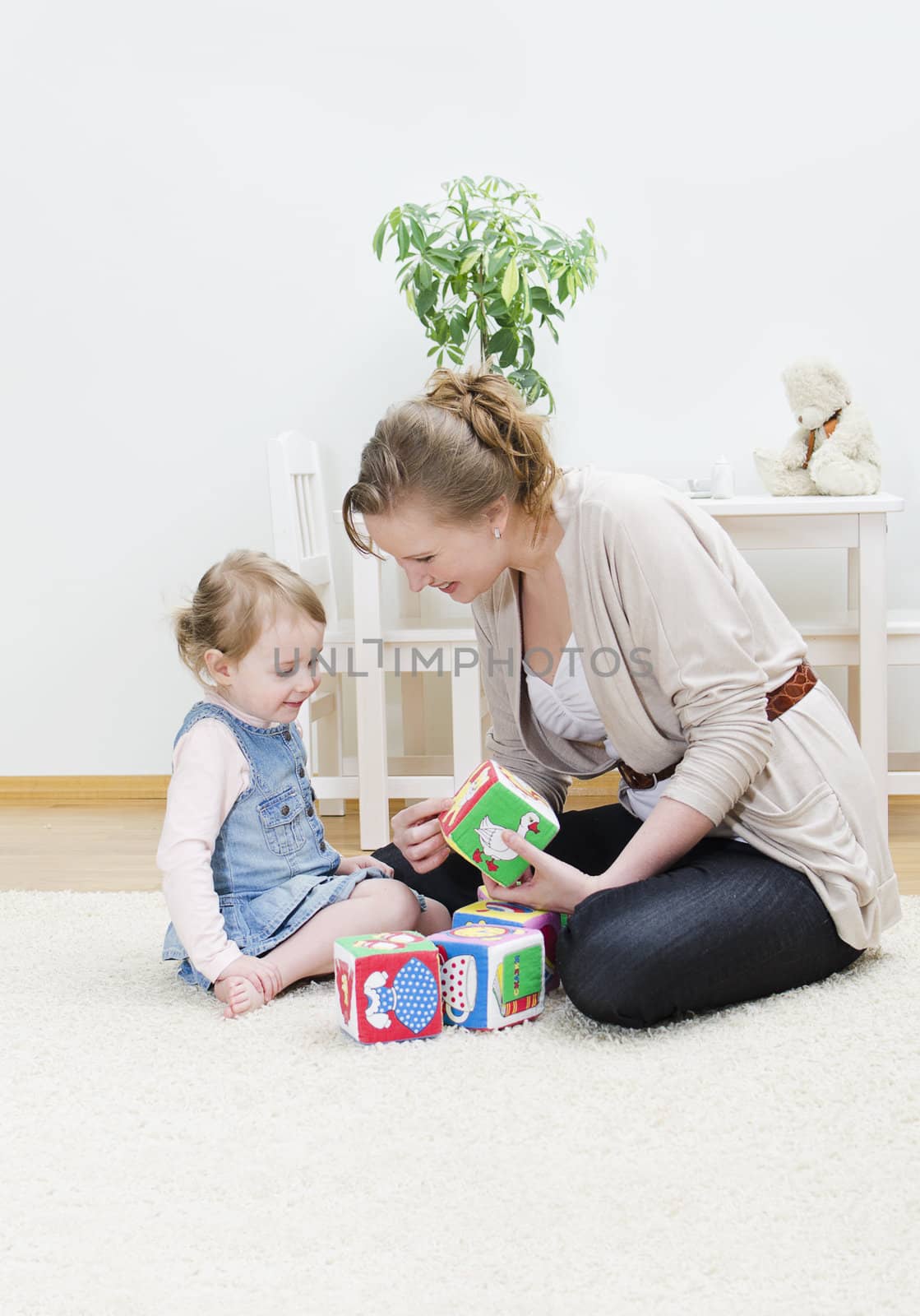 Mother and daughter playing in the children's cubes