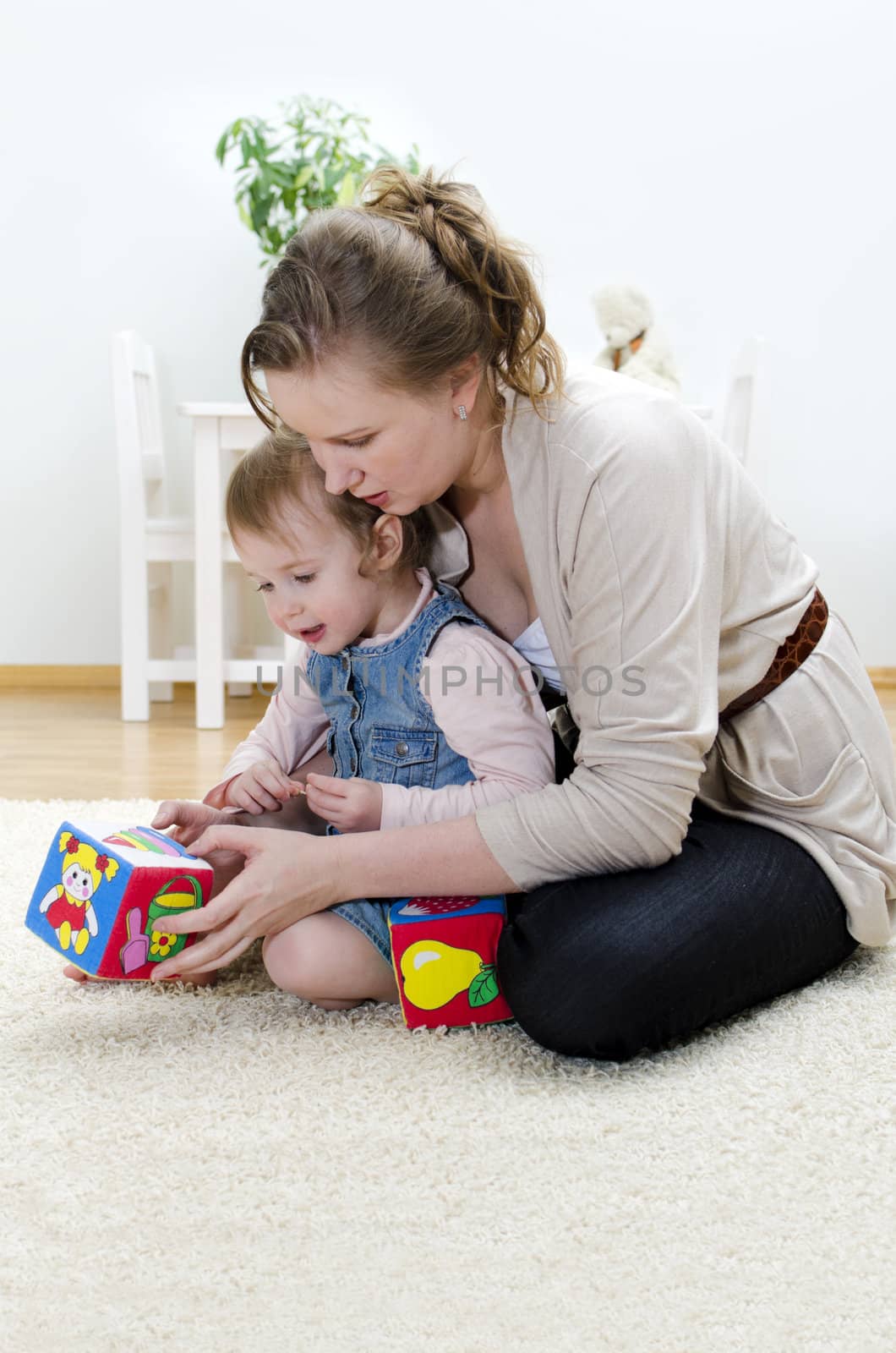 Mother and daughter playing in the children's cubes