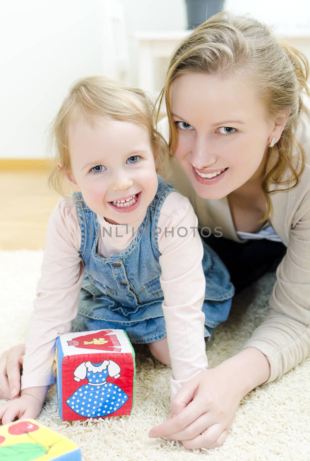 Mother and daughter playing in the children's cubes