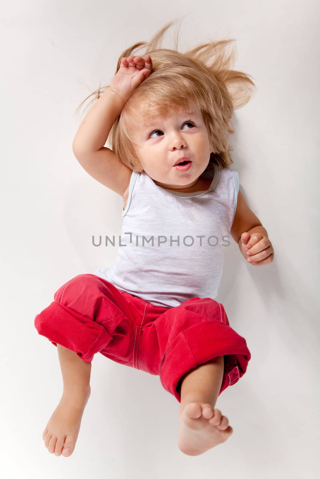 Funny boy in red pants, high angle view 