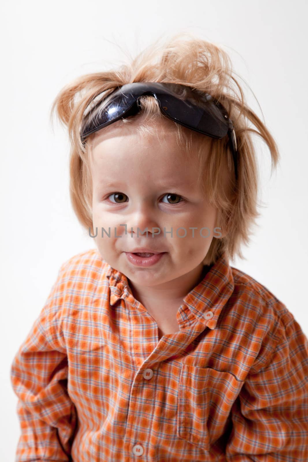 Portrait of cute little boy in sunglasses, studio shot 