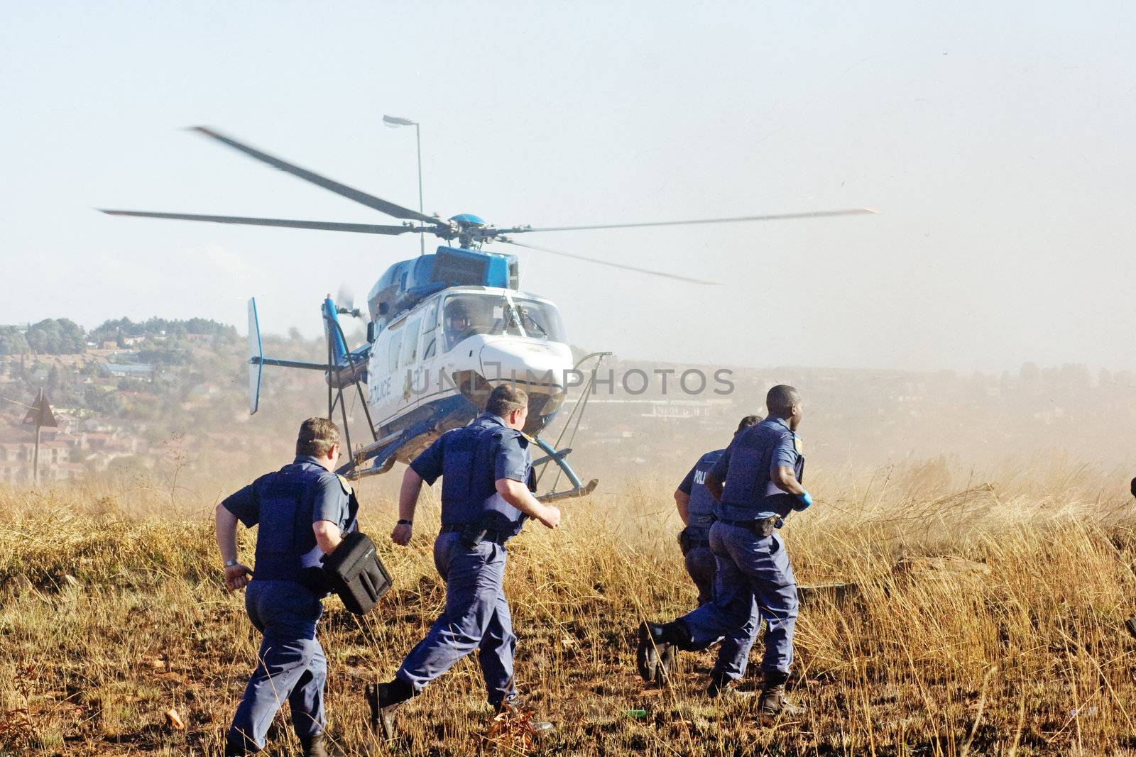 South African Police members and helicopter.