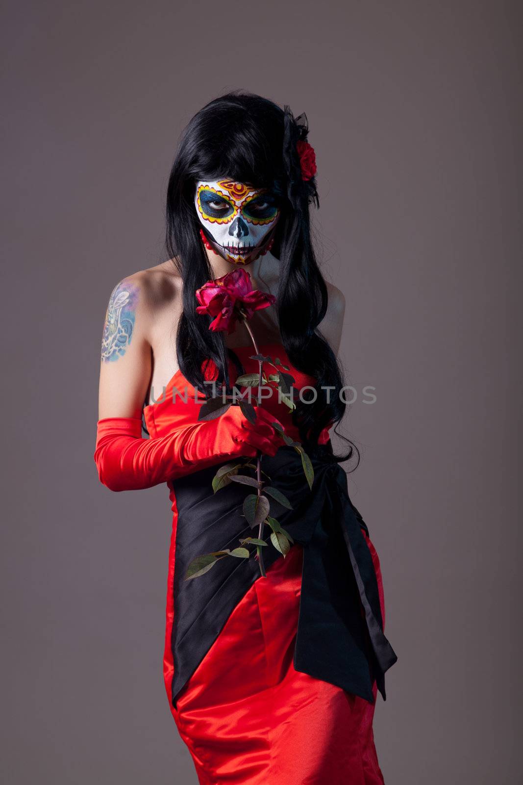 Sugar skull girl with rose, studio shot 