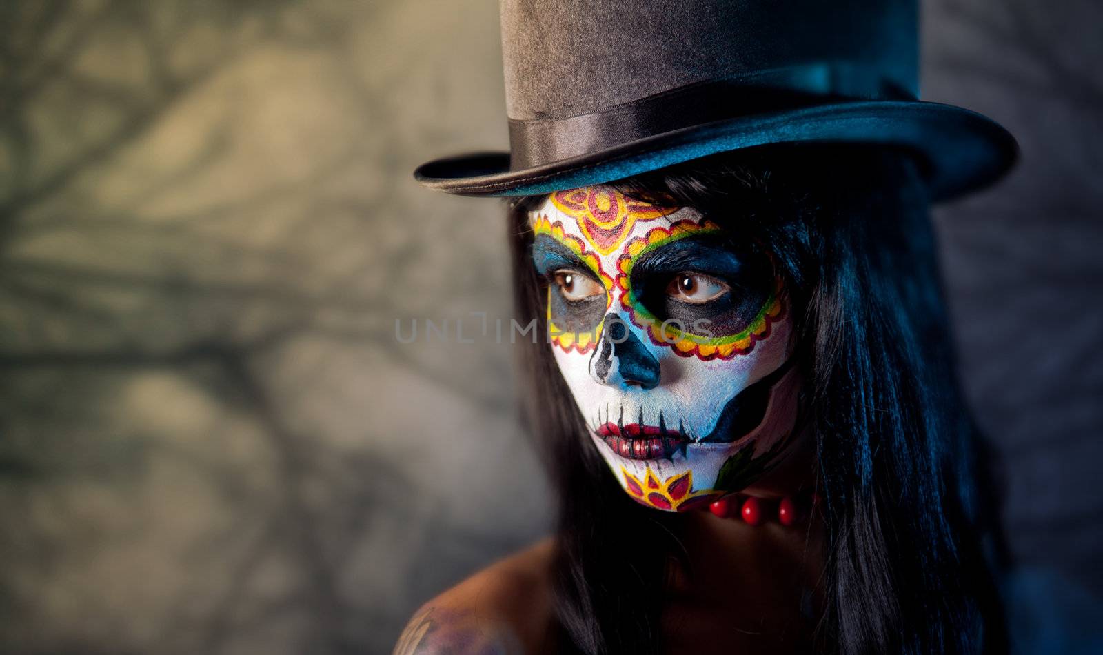 Sugar skull girl in tophat, in the forest 