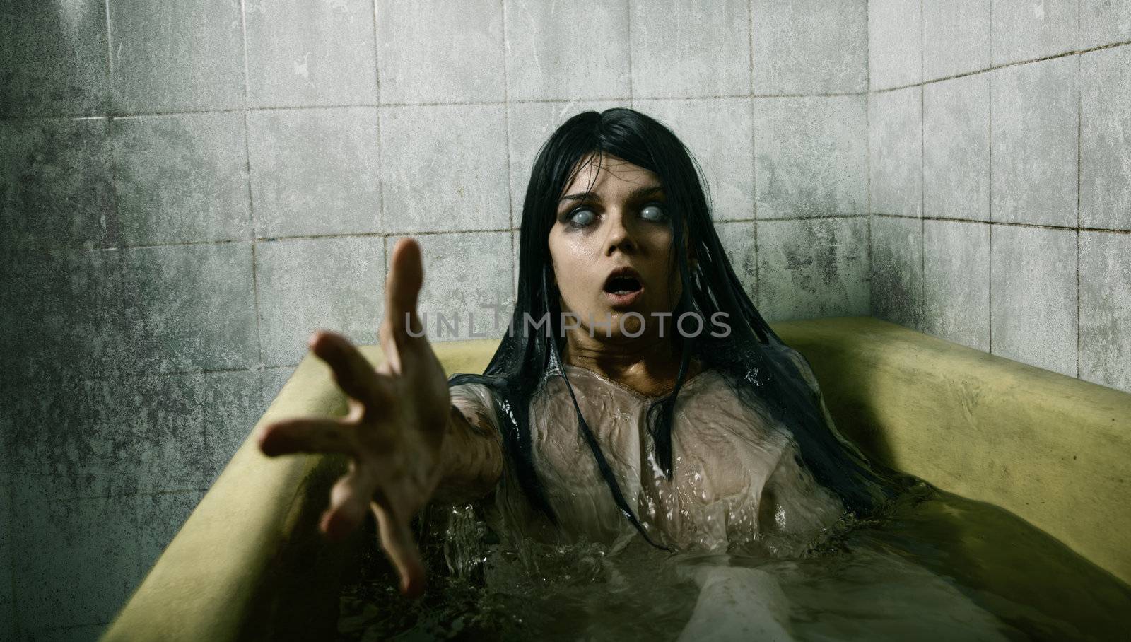 Scary girl in bath stretching her hand to camera, Halloween theme 