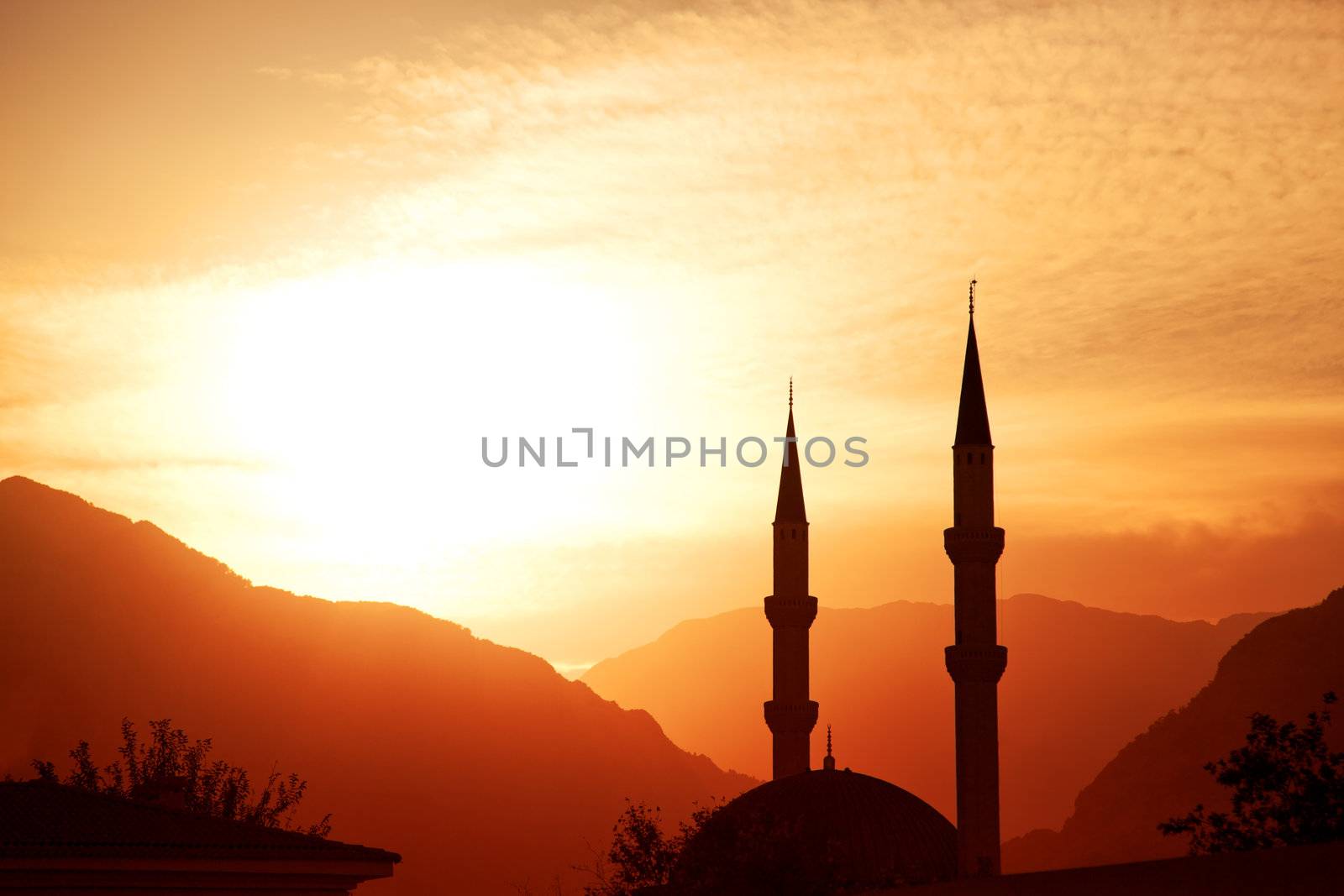 Mosque silhouette at sunset, with mountains on background, Turkey, Kemer 