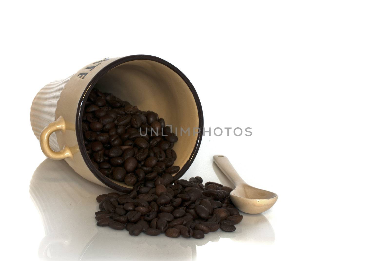 coffe cup with beans and spoon isolated on white