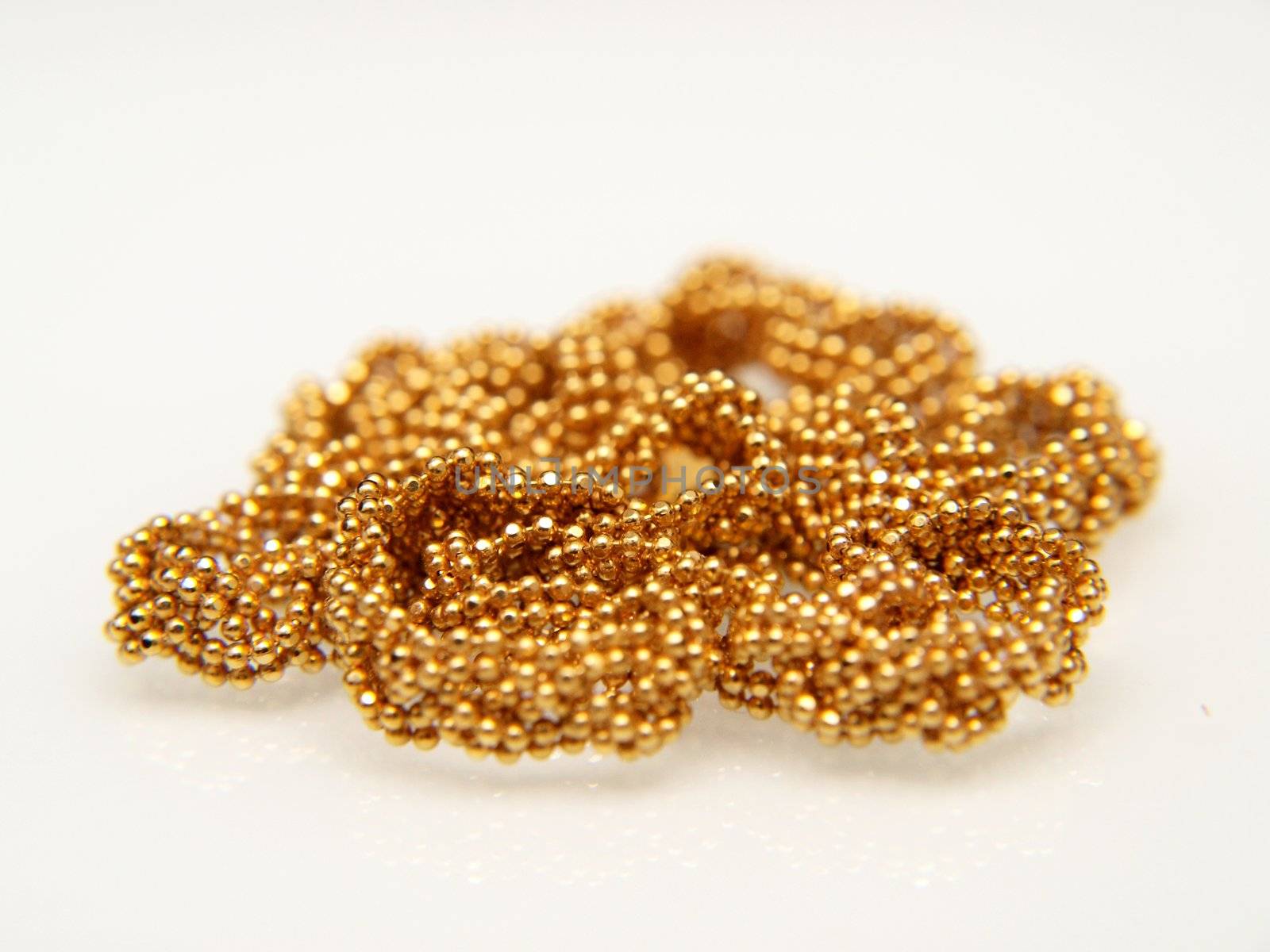 Yellow gold jewellry, isolated towards white background