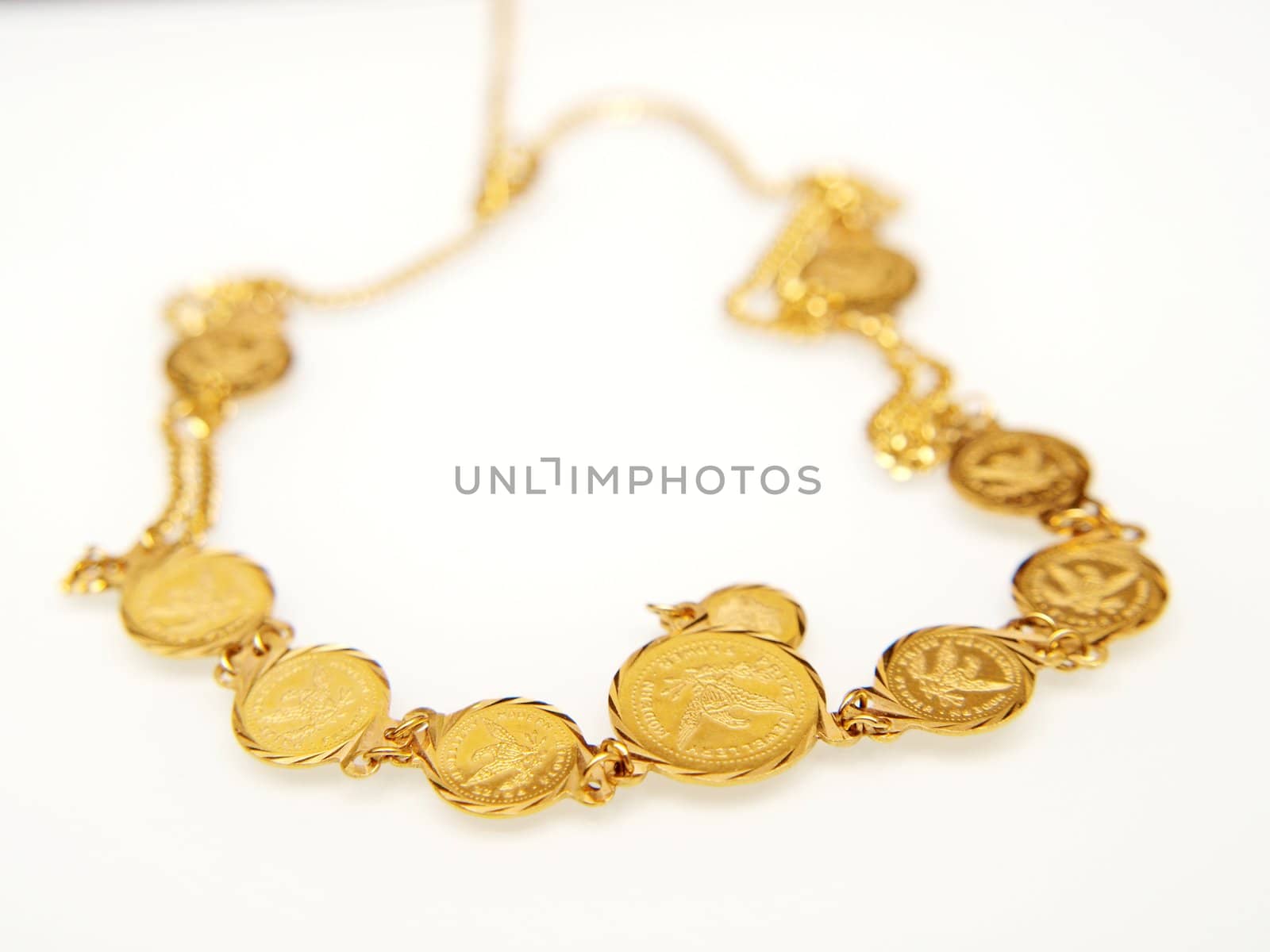 Yellow gold jewellry, isolated towards white background