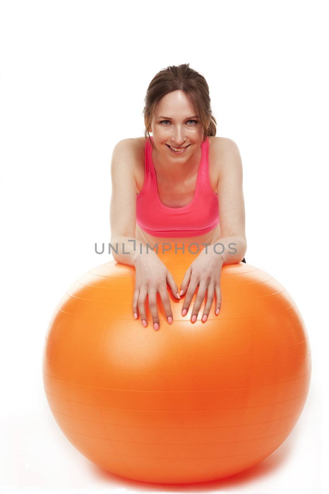 young woman resting with a fitness ball on white background
