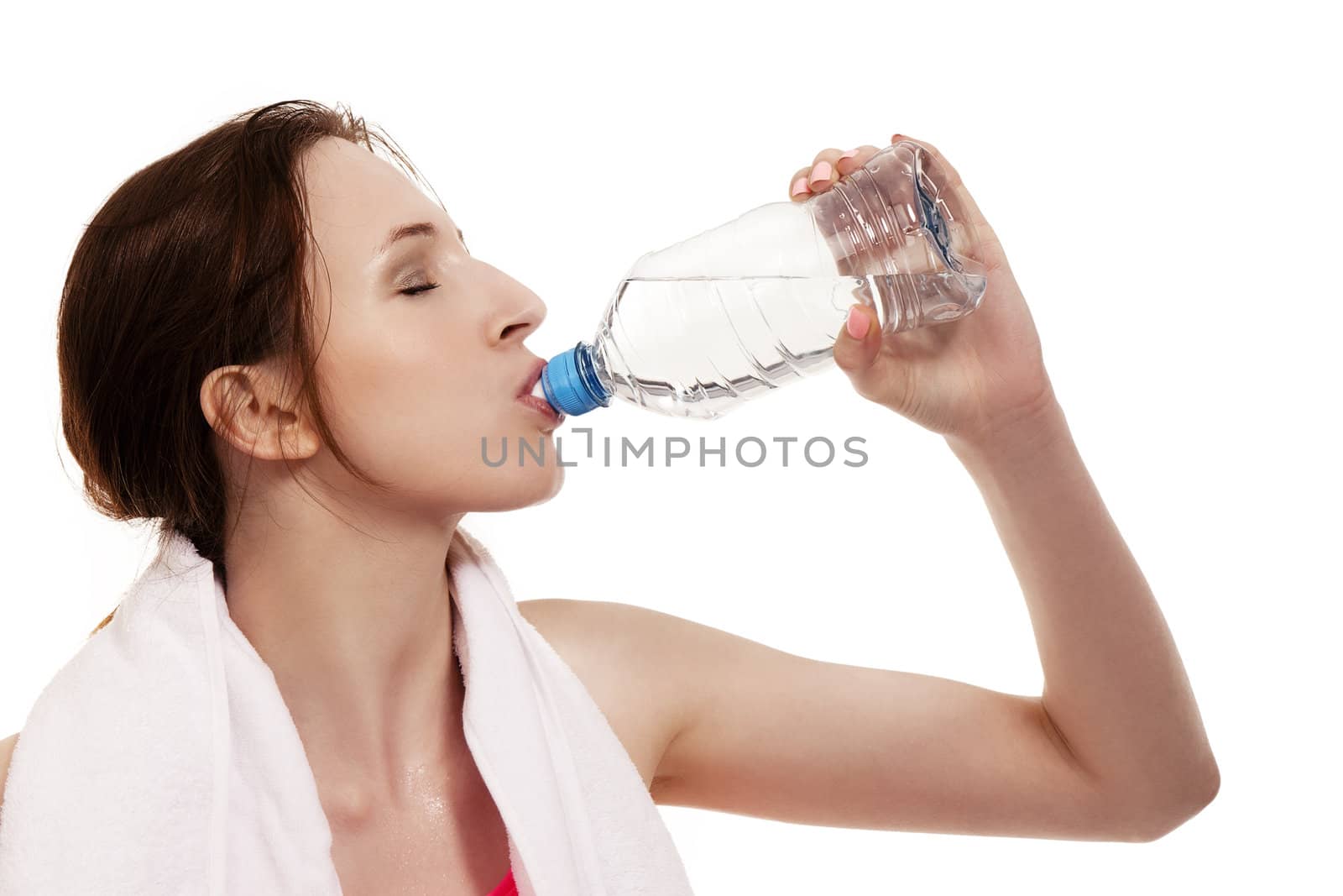 young sporty woman drinking water on white background