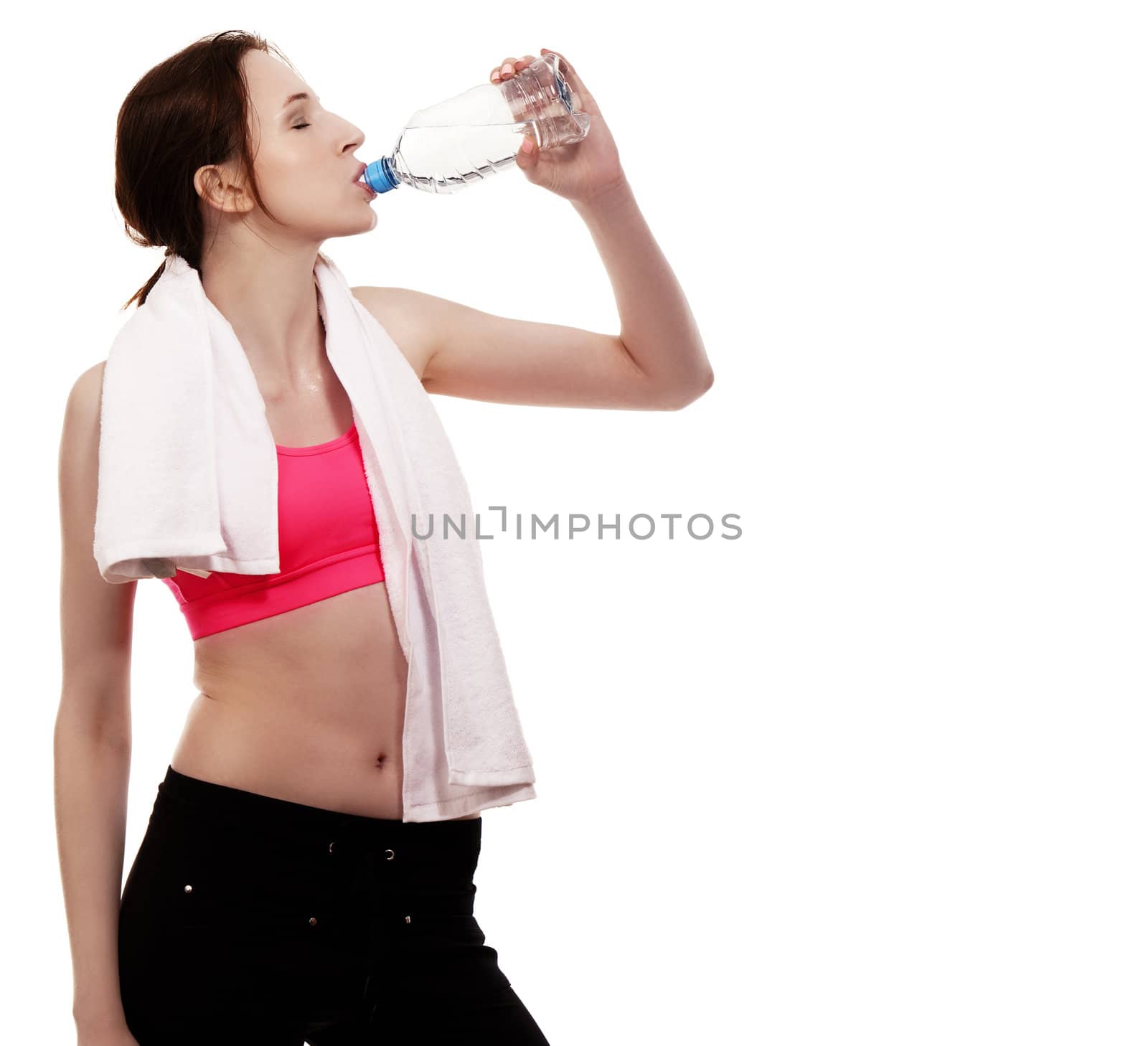 young sporty woman drinking water on white background