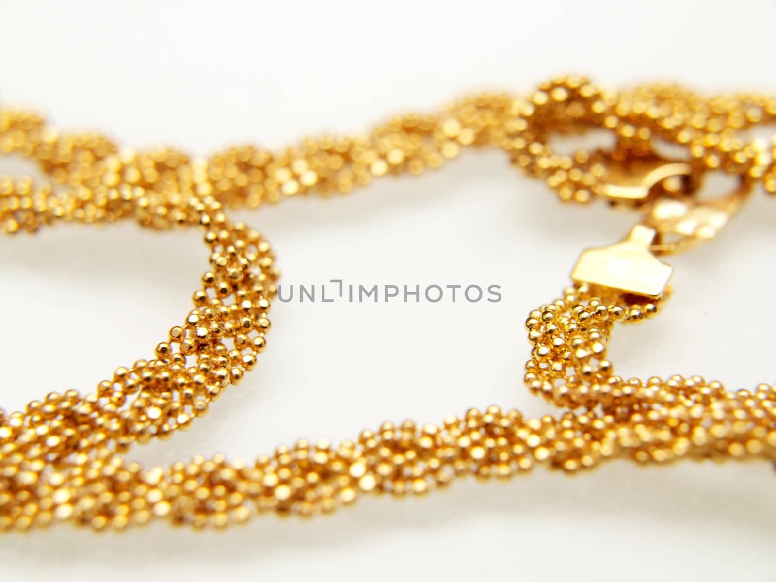 Yellow gold jewellry, isolated towards white background