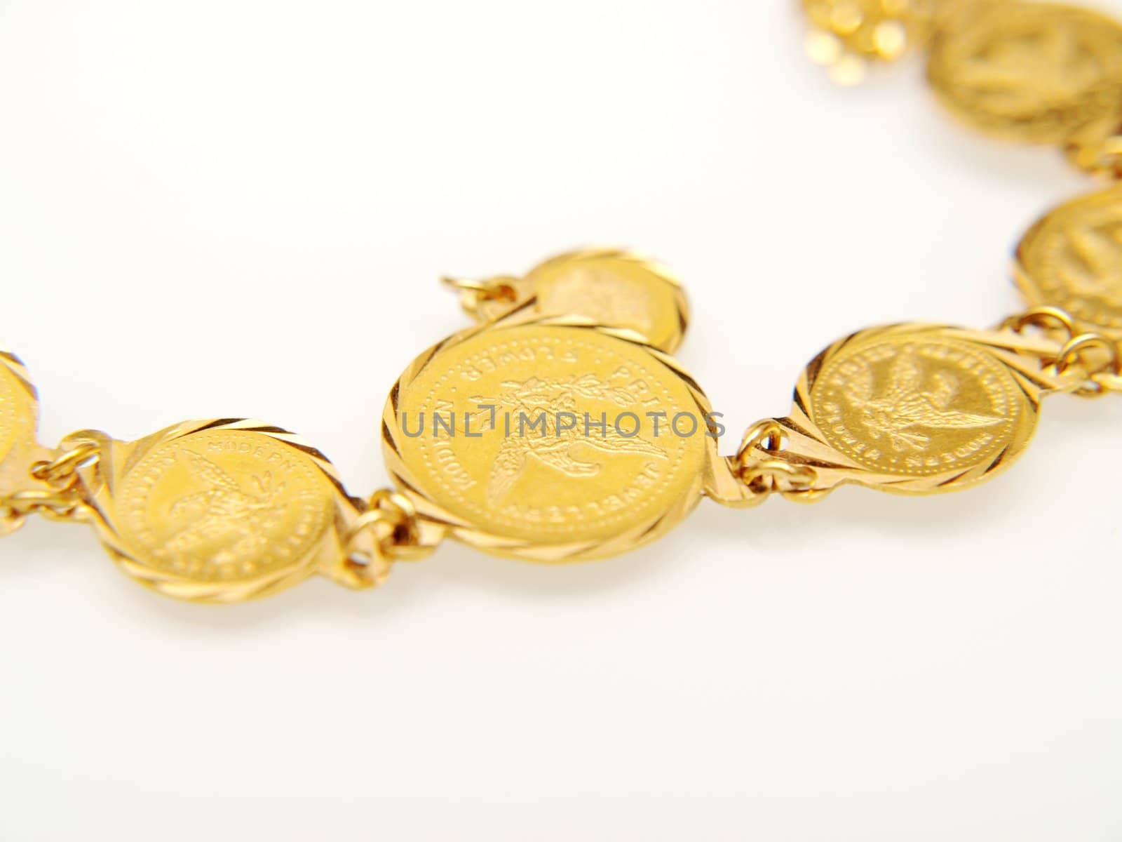 Yellow gold jewellry, isolated towards white background