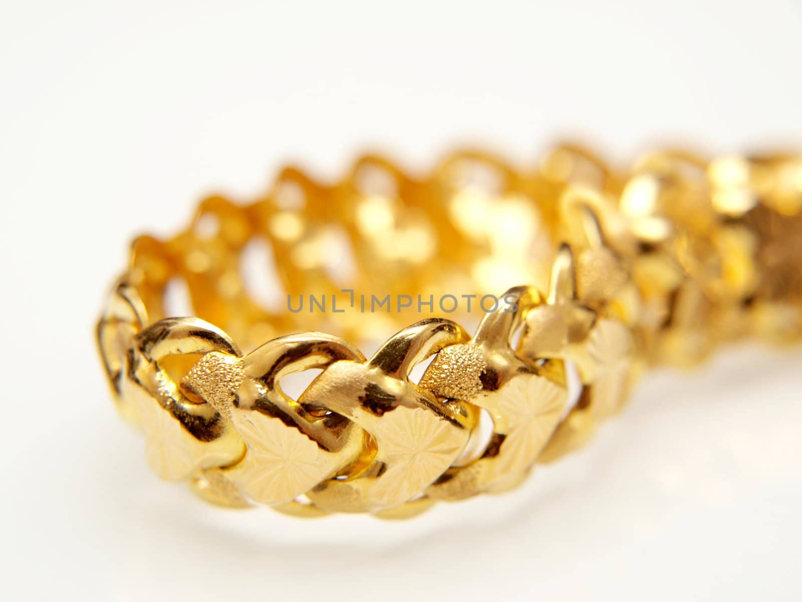 Yellow gold jewelry, isolated towards white background