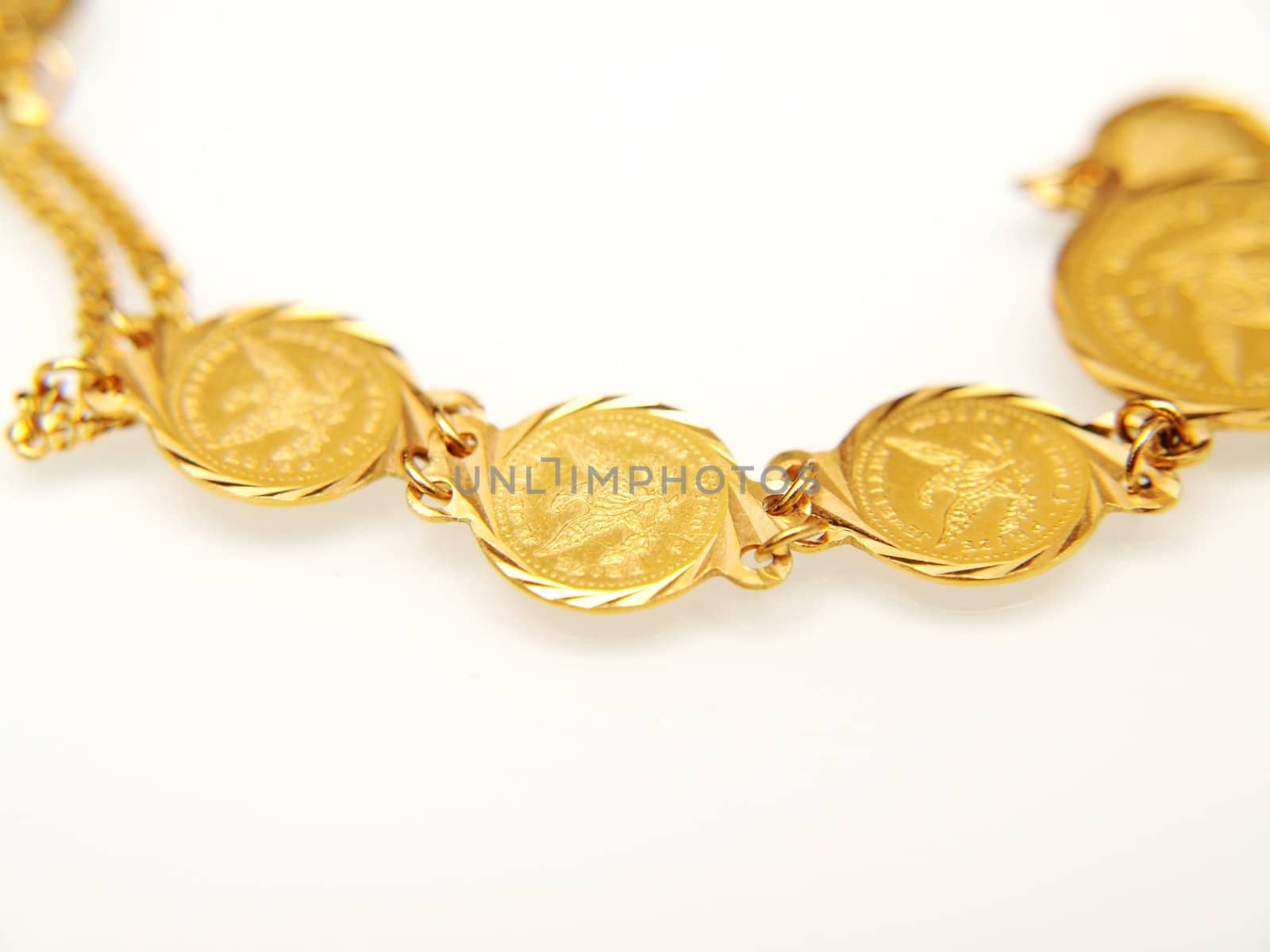 Yellow gold jewelry, isolated towards white background