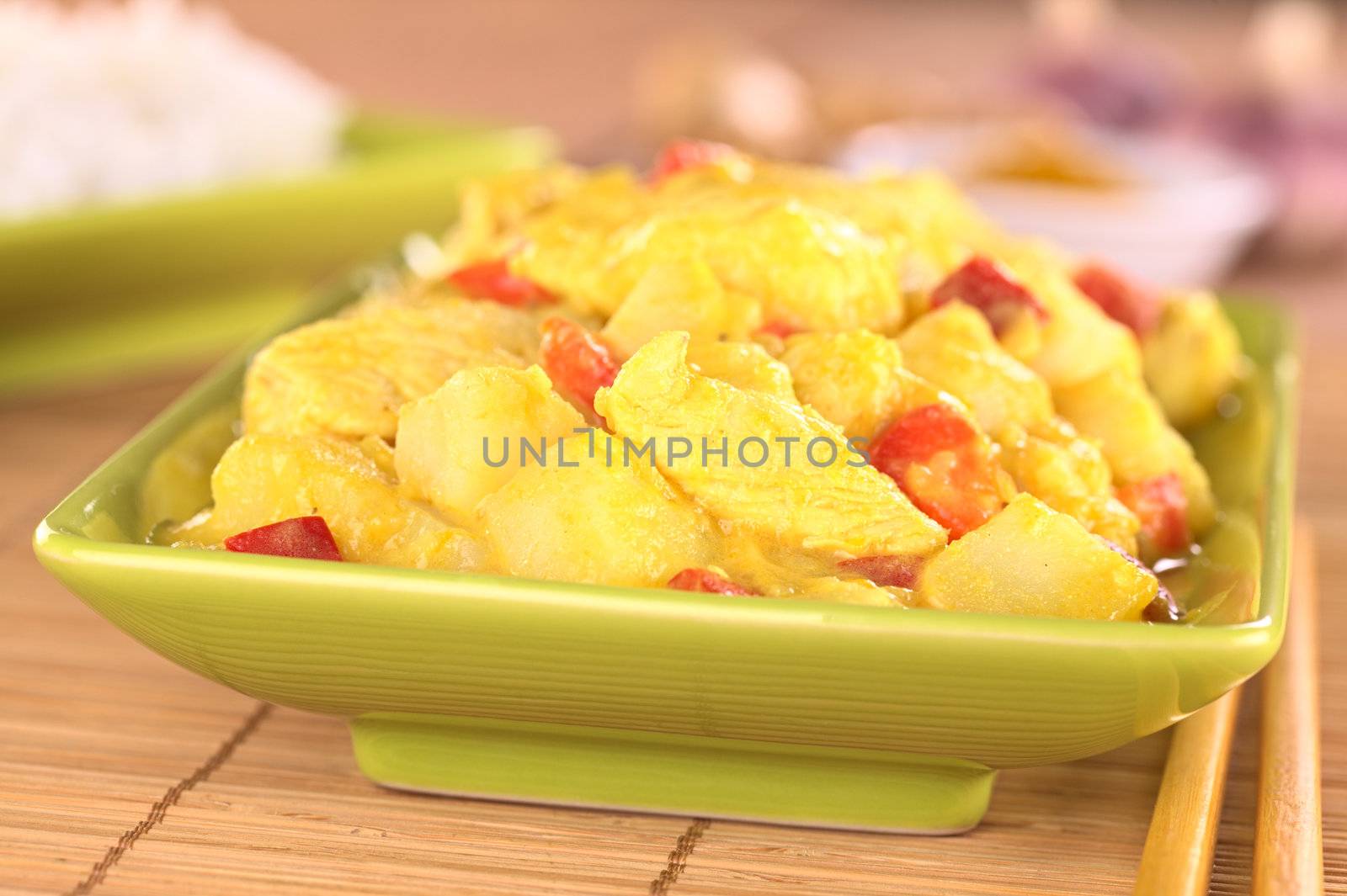 Chicken-mango curry with red bell pepper and potatoes (Selective Focus, Focus on the chicken piece in the front)