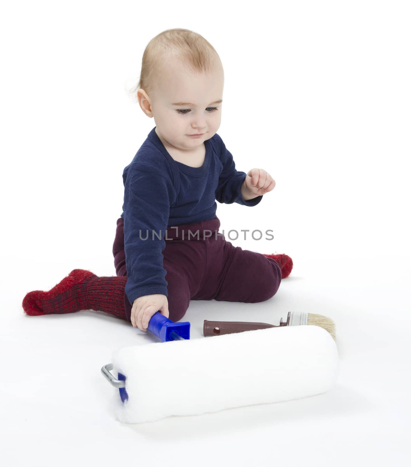 young child with painters equipment in light background