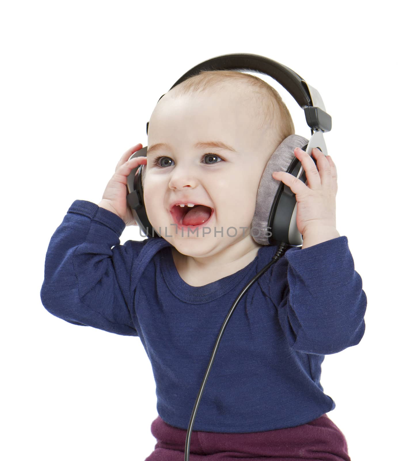 young child with ear-phones listening to music by gewoldi