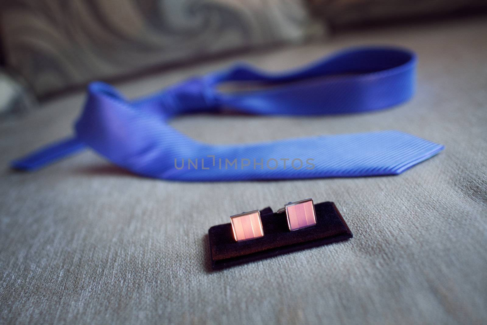 cufflinks and necktie on the sofa