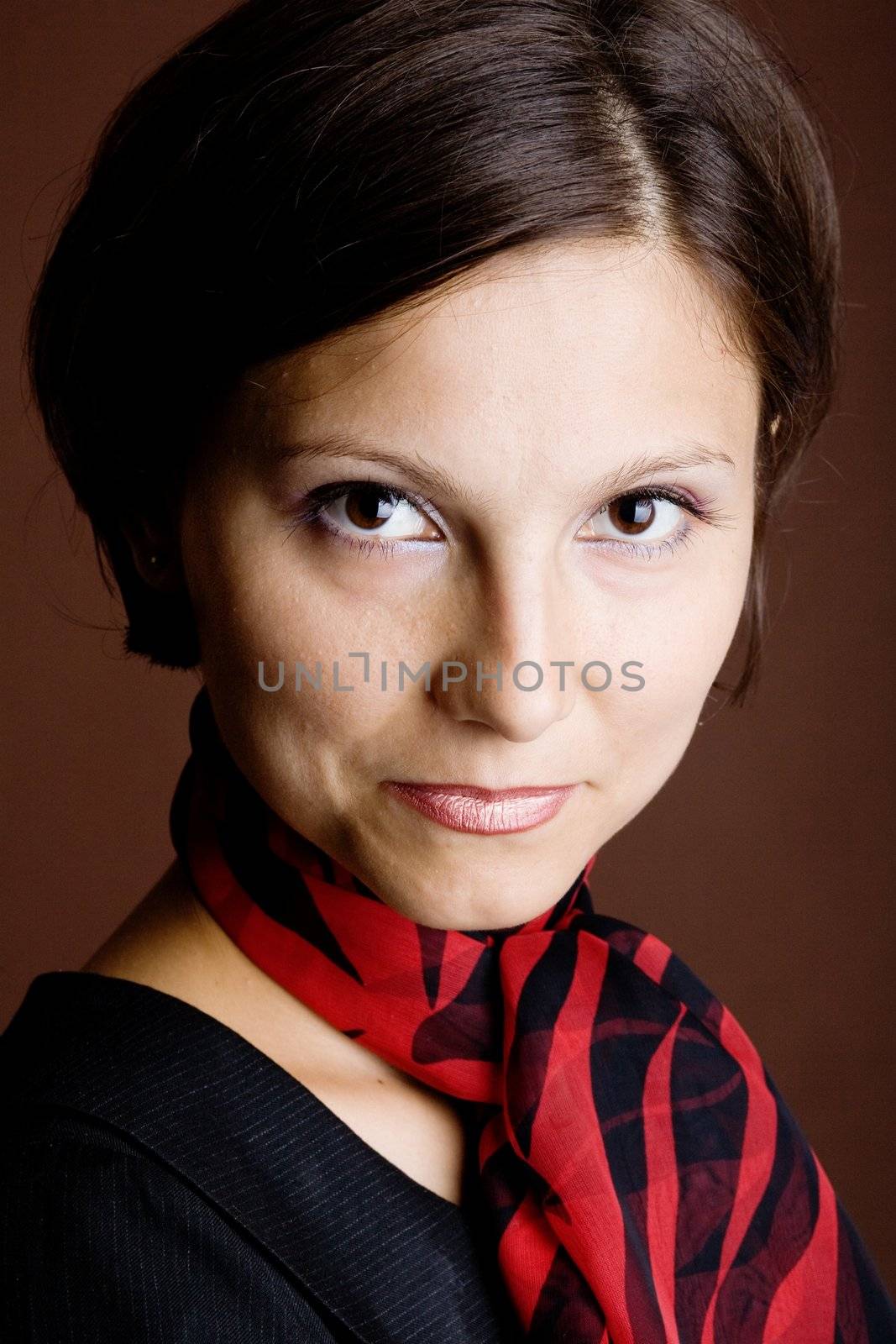 An image of a young woman in a scarf