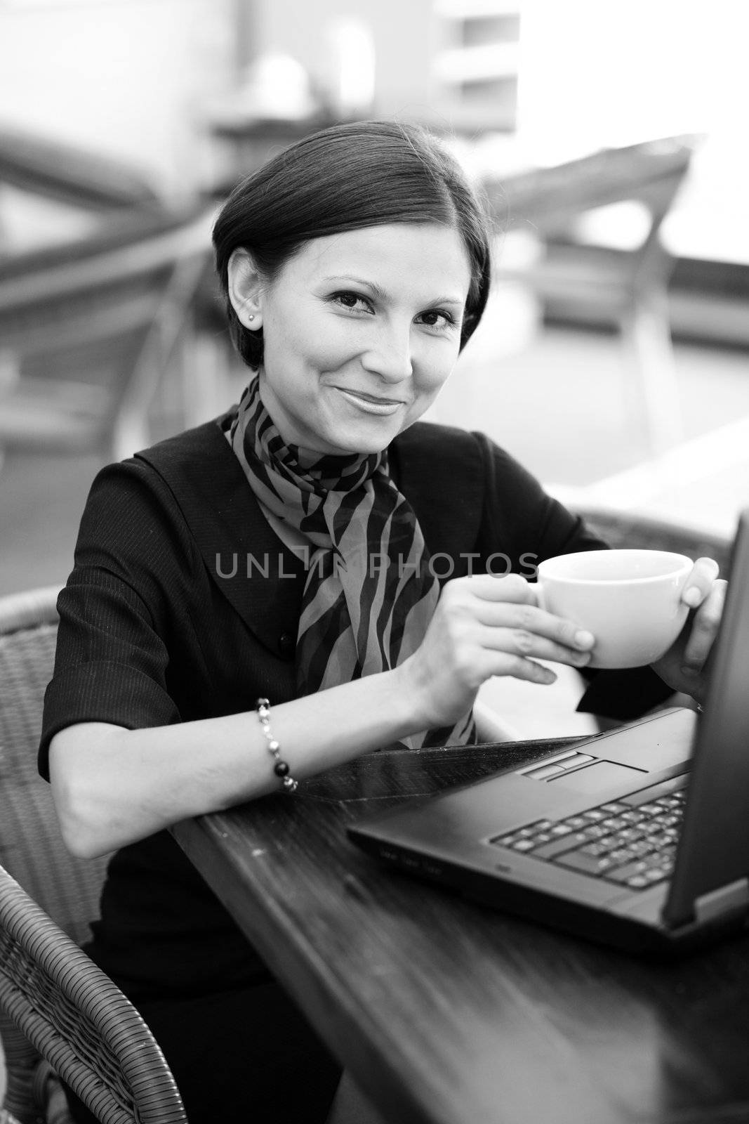 A beautiful woman with a cup in a cafe 