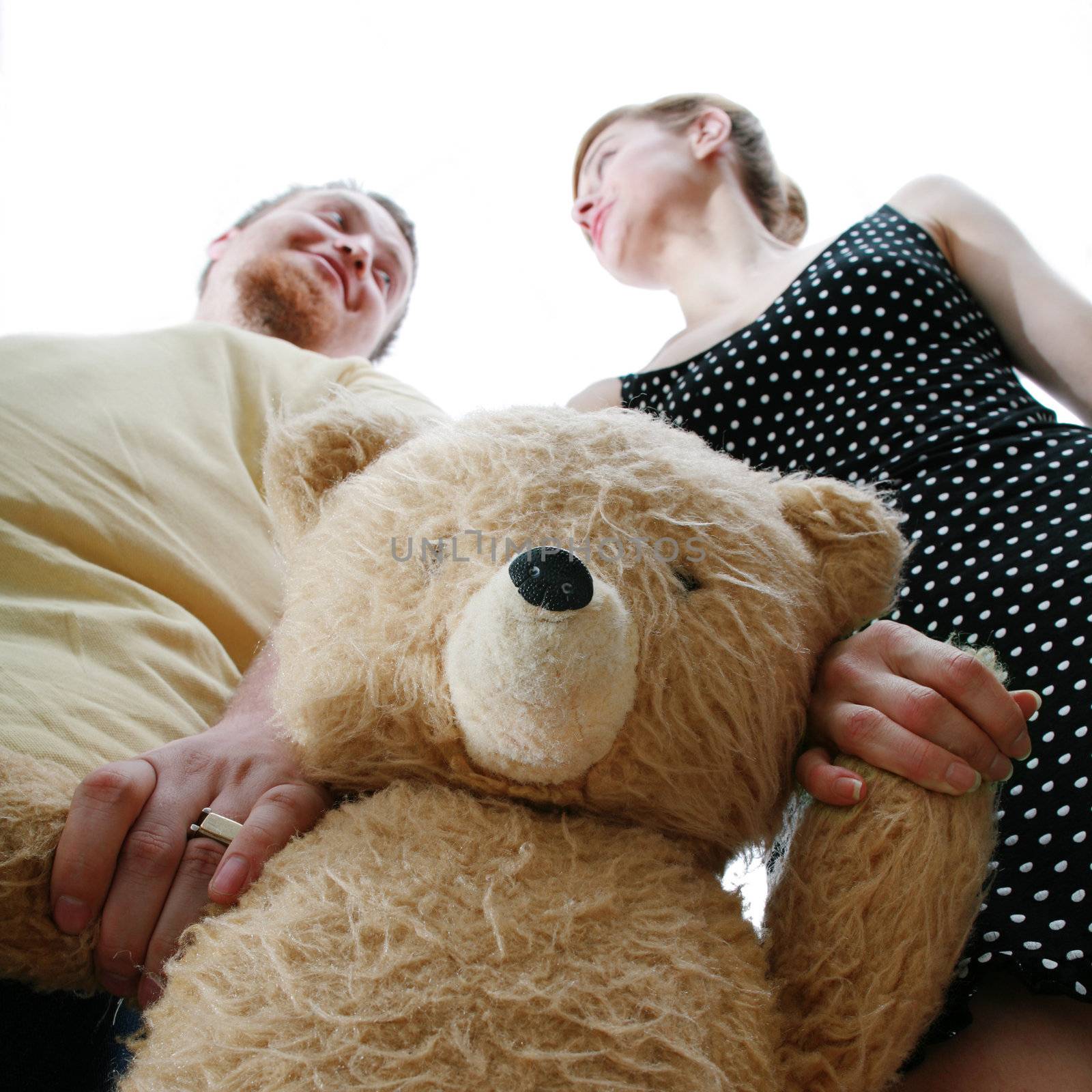 An image of a man and a woman with a teddy-bear