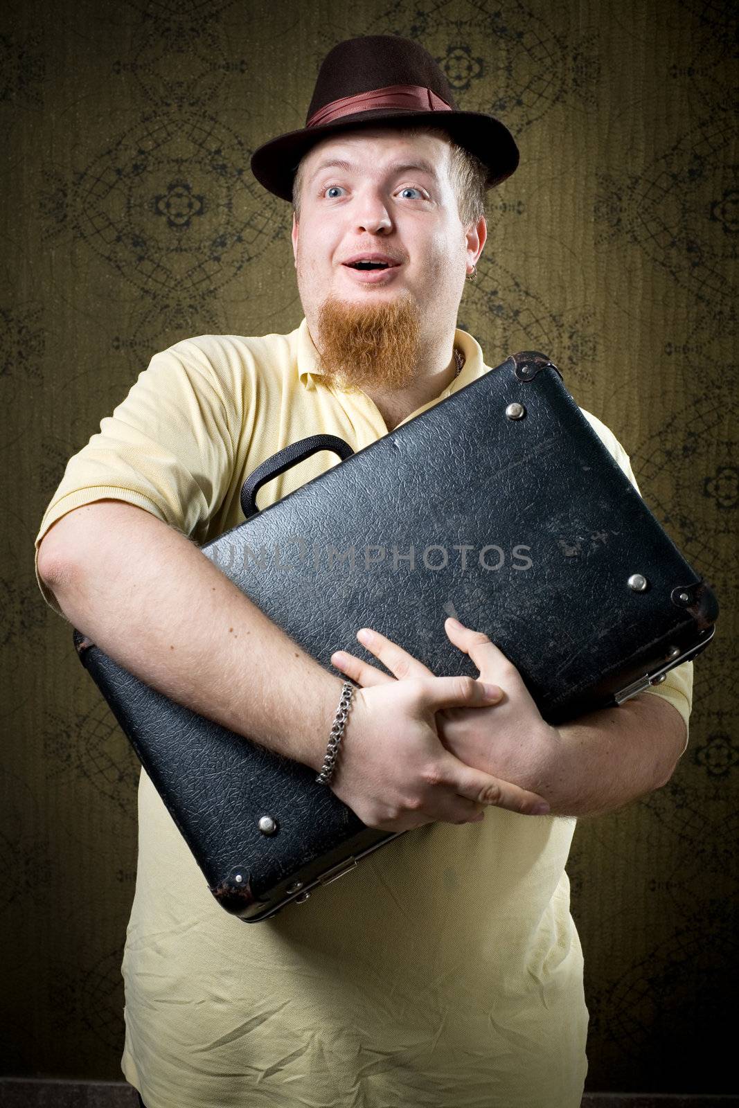 An image of a man with an old  black case