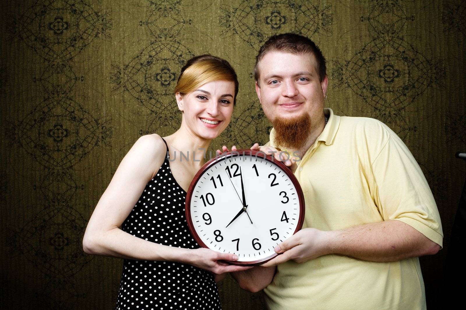An image of a man and a woman with a clock