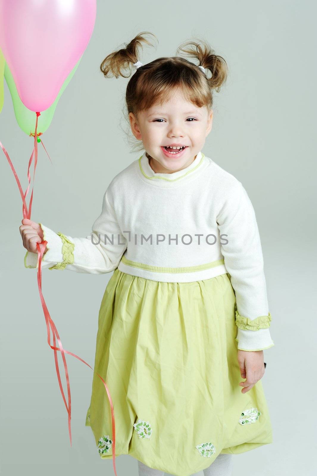 A portrait of a gay little girl with balloons