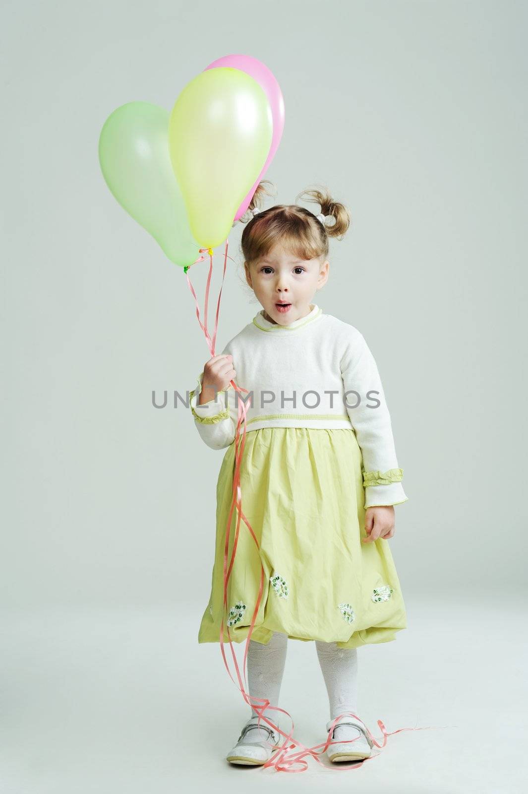 A portrait of a little girl with three balloons