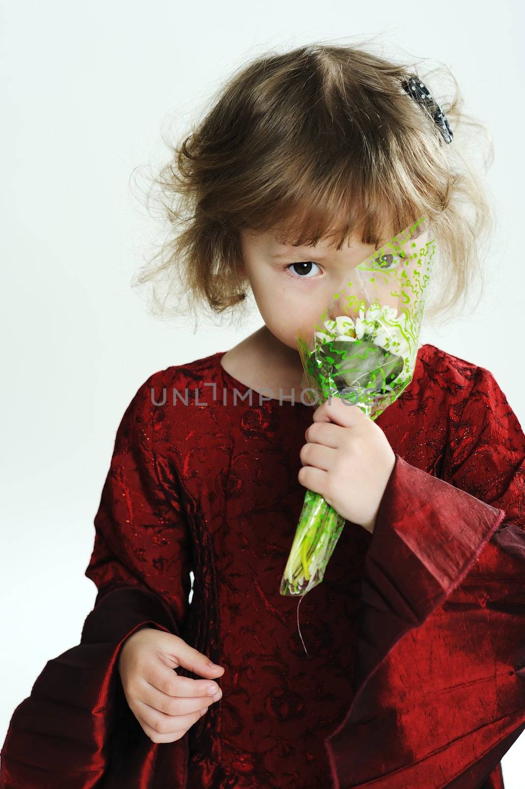 An image of a little girl with white flowers