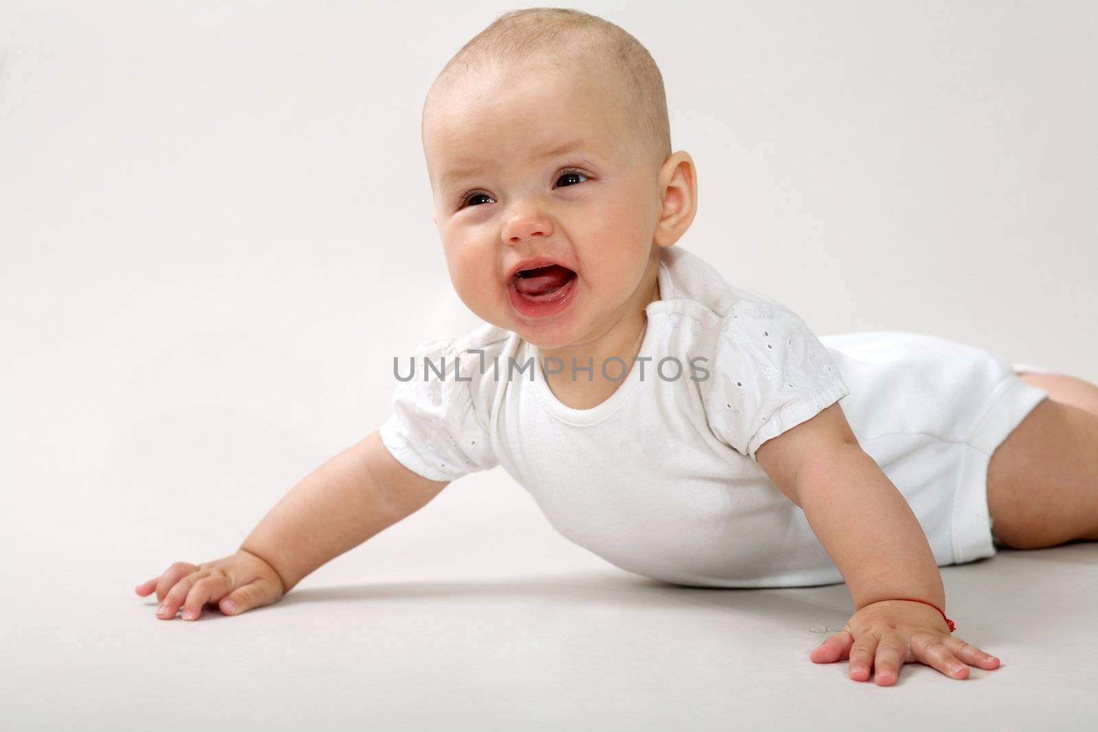 An image of a little baby crawning in studio