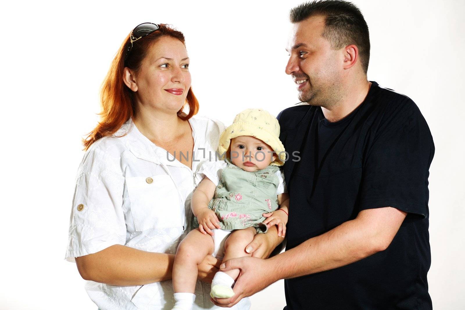 Family portrait in studio. Parents with a child.