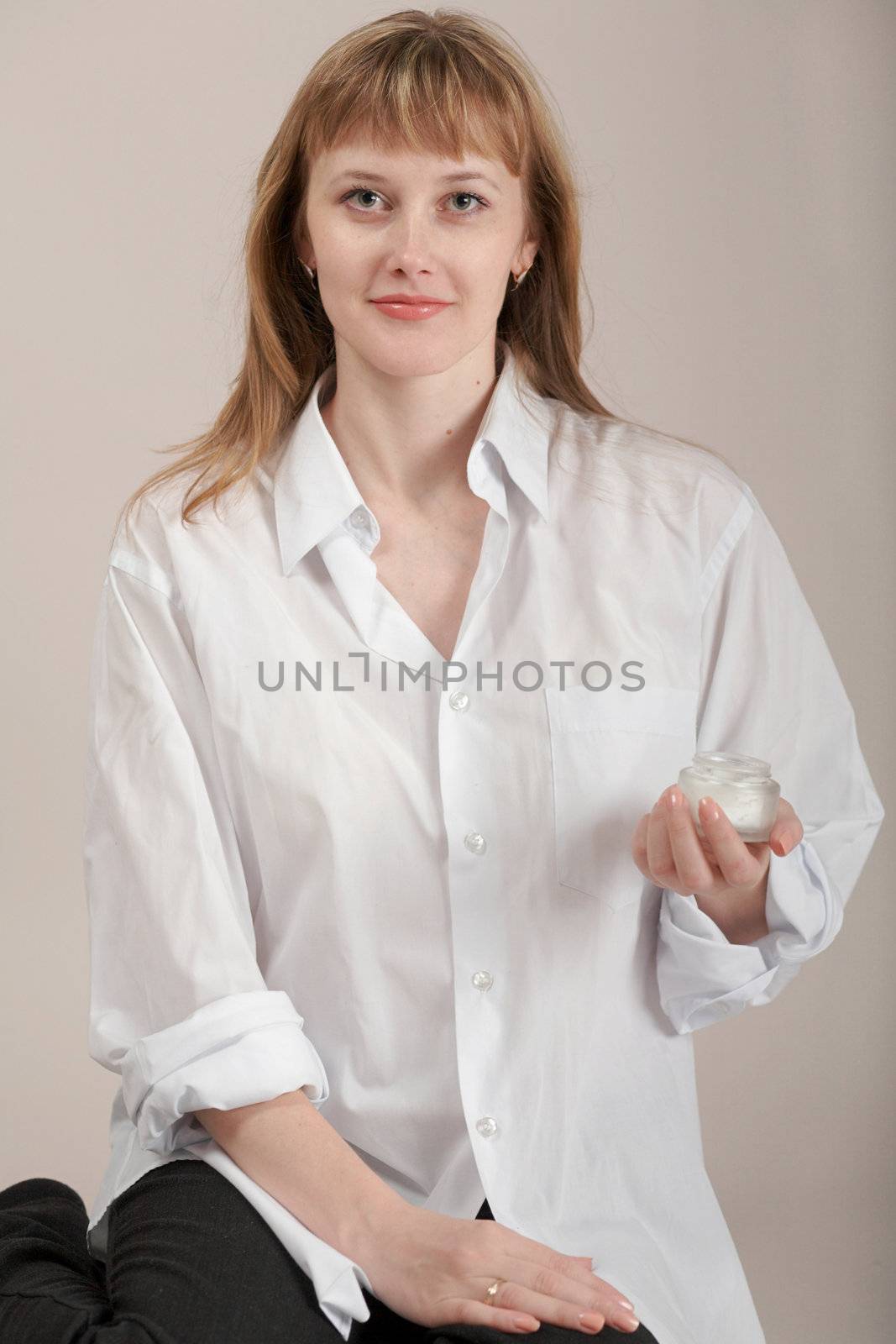 A girl in white shirt with cream for make-up