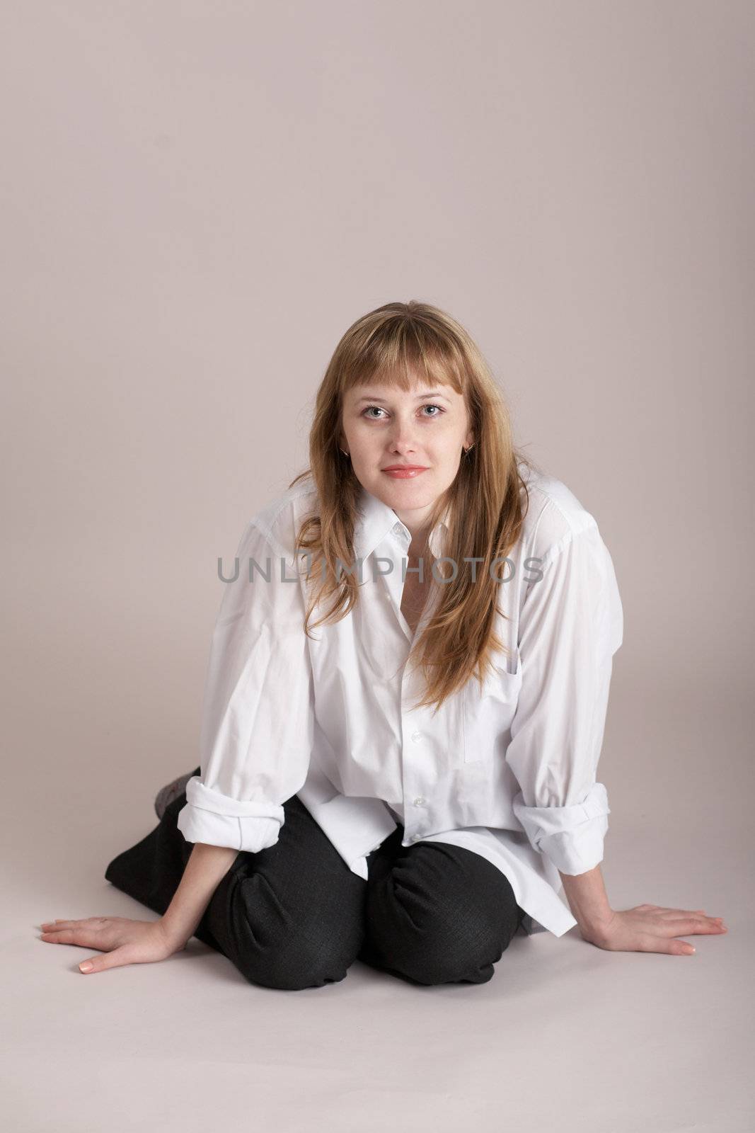 An image of nice woman sitting on neutral background