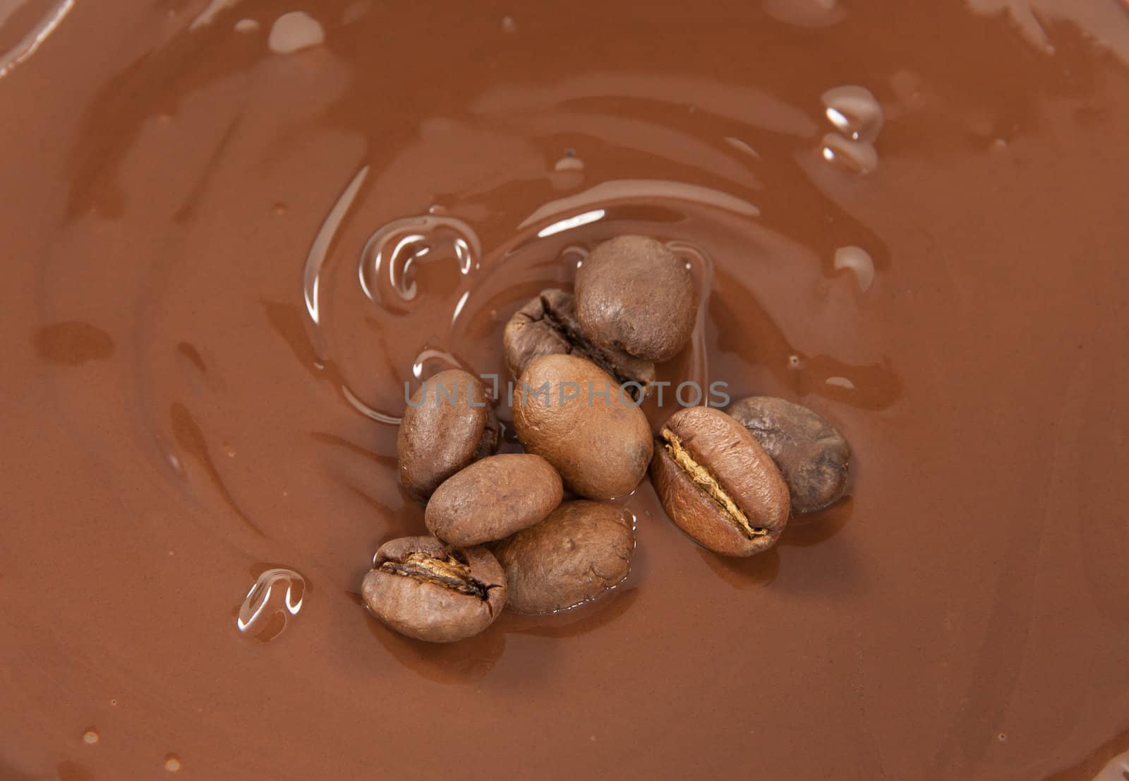 Coffee beans lying on a bed of chocolate