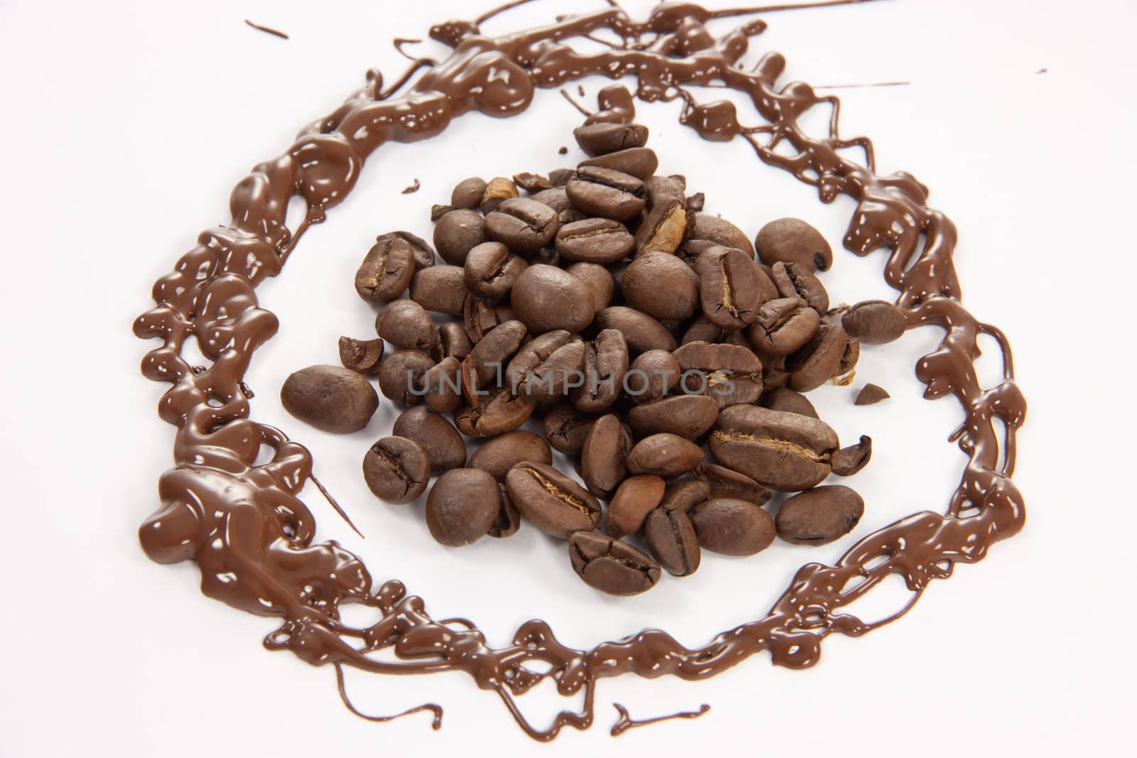 Coffee beans surrounded by melted chocolate.