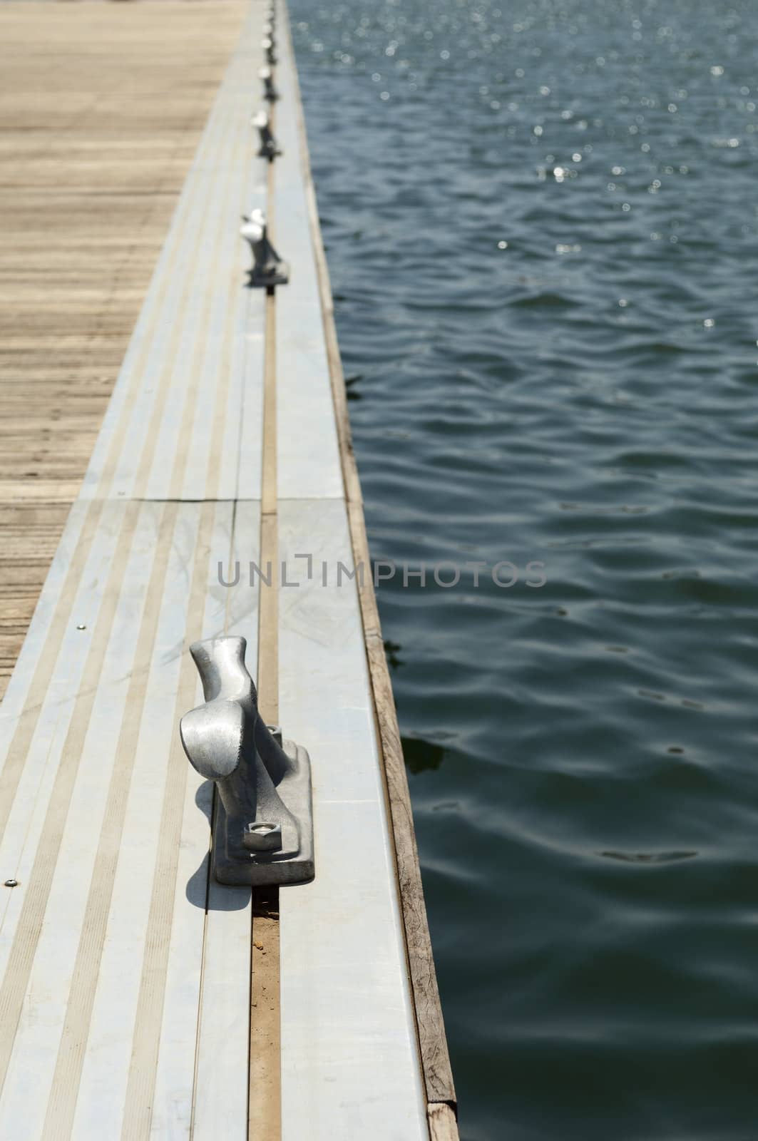 Detail of a wooden floating dock with mooring bitts
