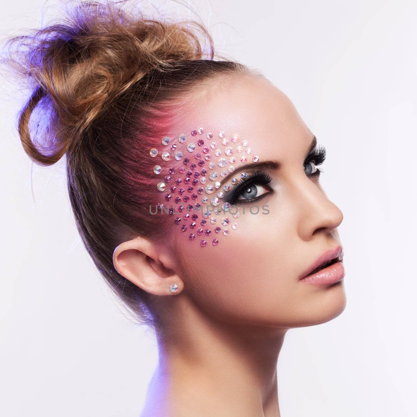 Beautiful woman with fantasy makeup on a white background