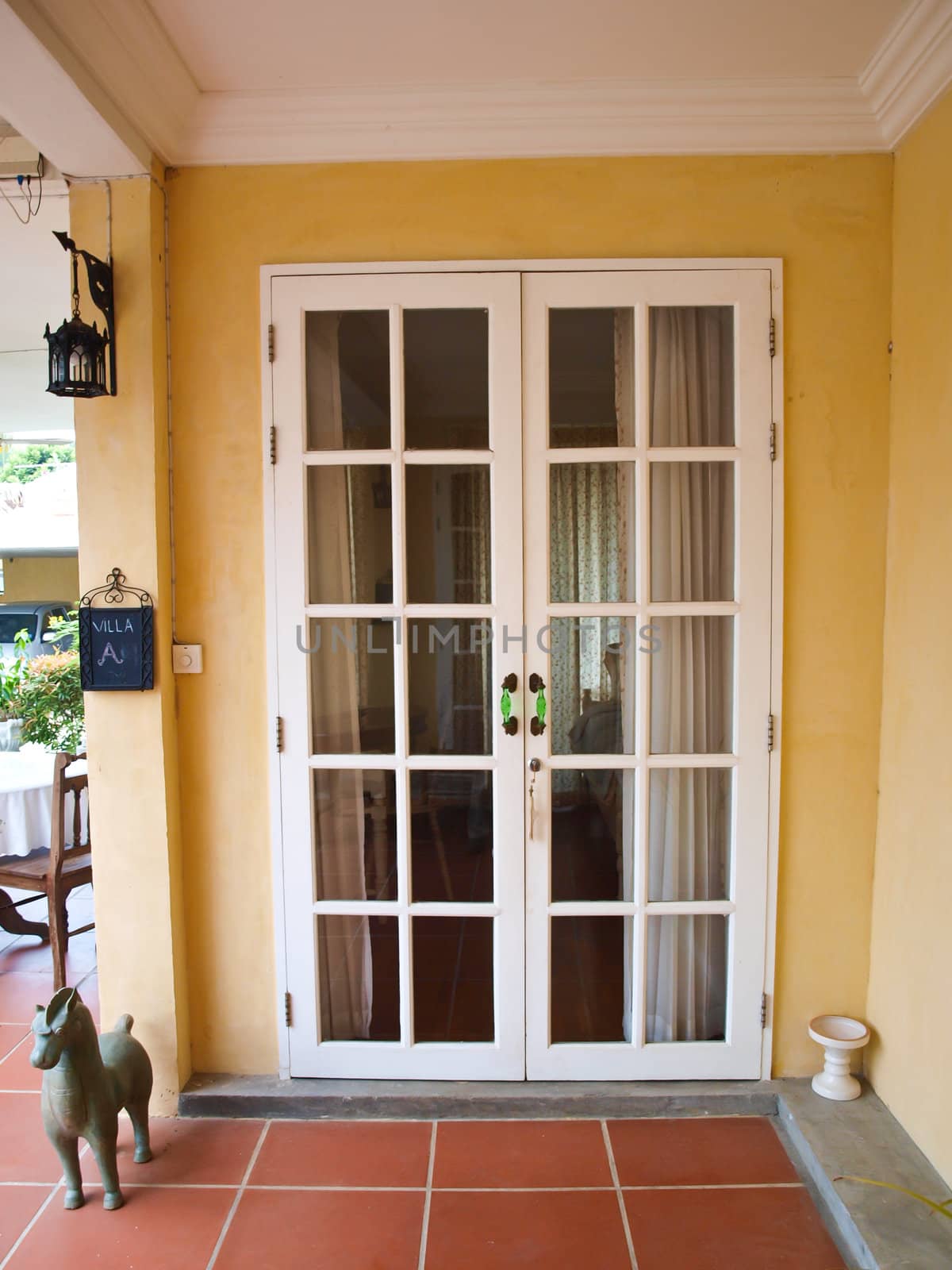 Double patio white french doors with windows on yellow wall by gururugu
