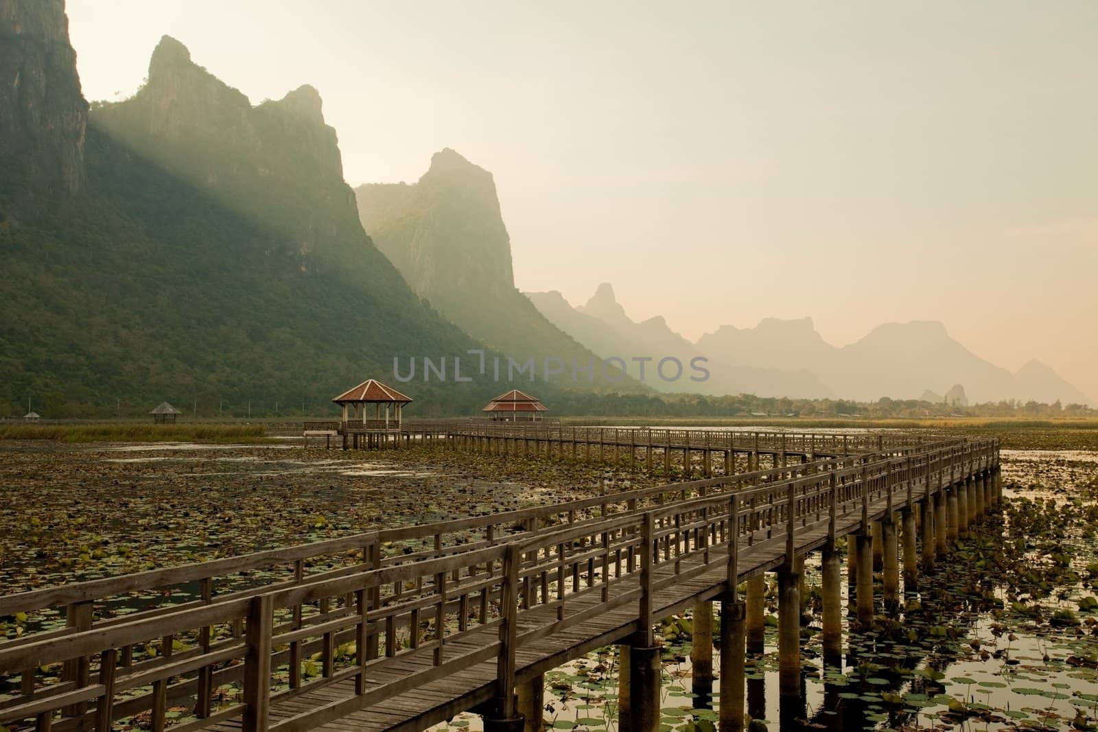 footbridge in lake into the mountain, thailand