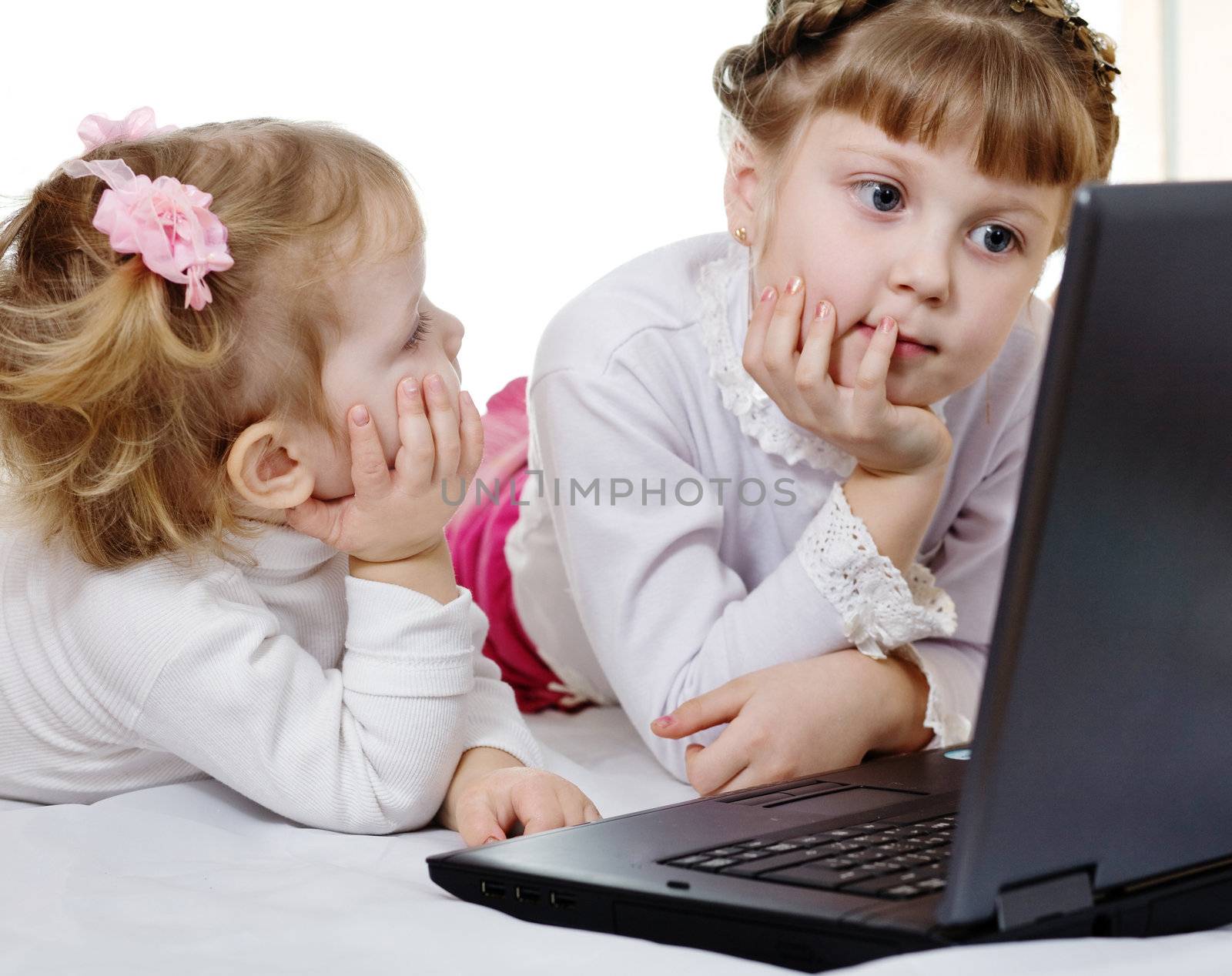 Stock photo: an image of two girls with a  laptop