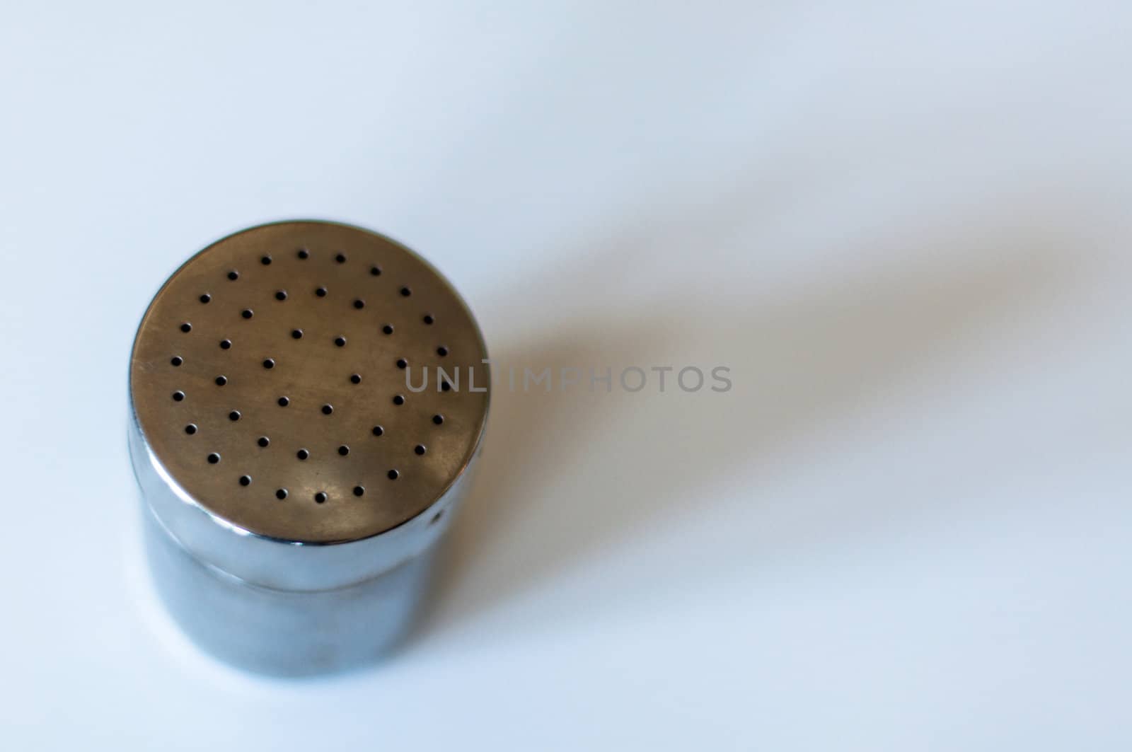 Modern chrome shaker with shadows on white with room for your text - like spice up your life