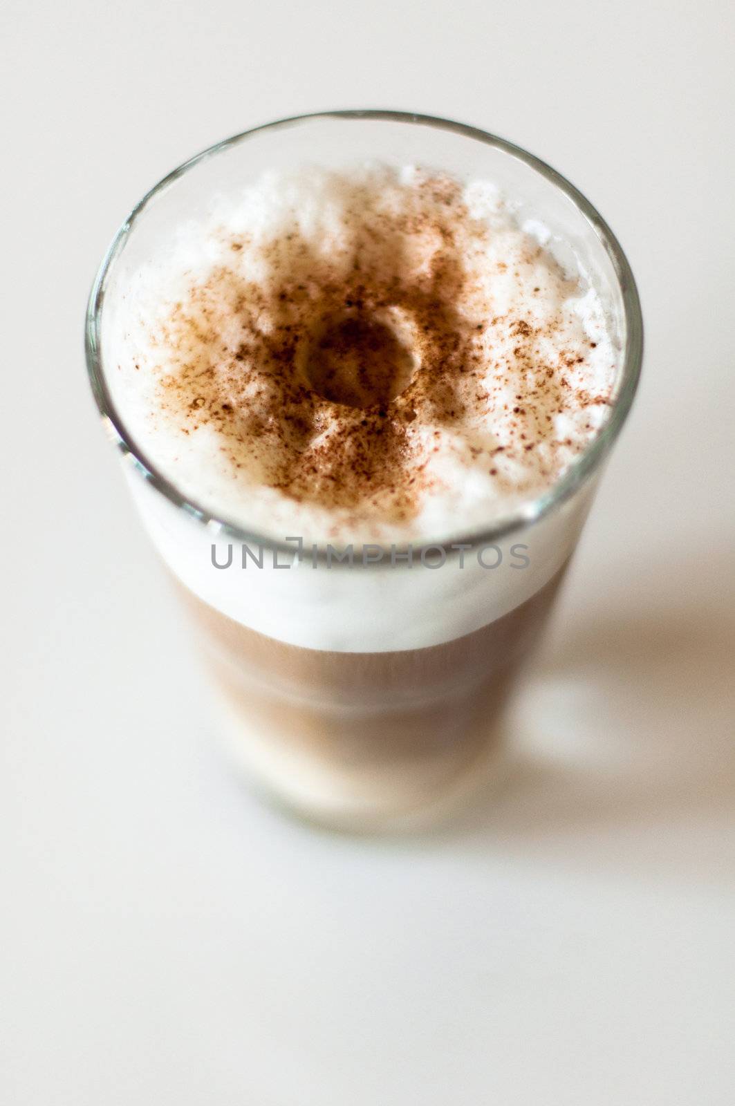 Coffee latte in a tall glass on white background shallow depth of field