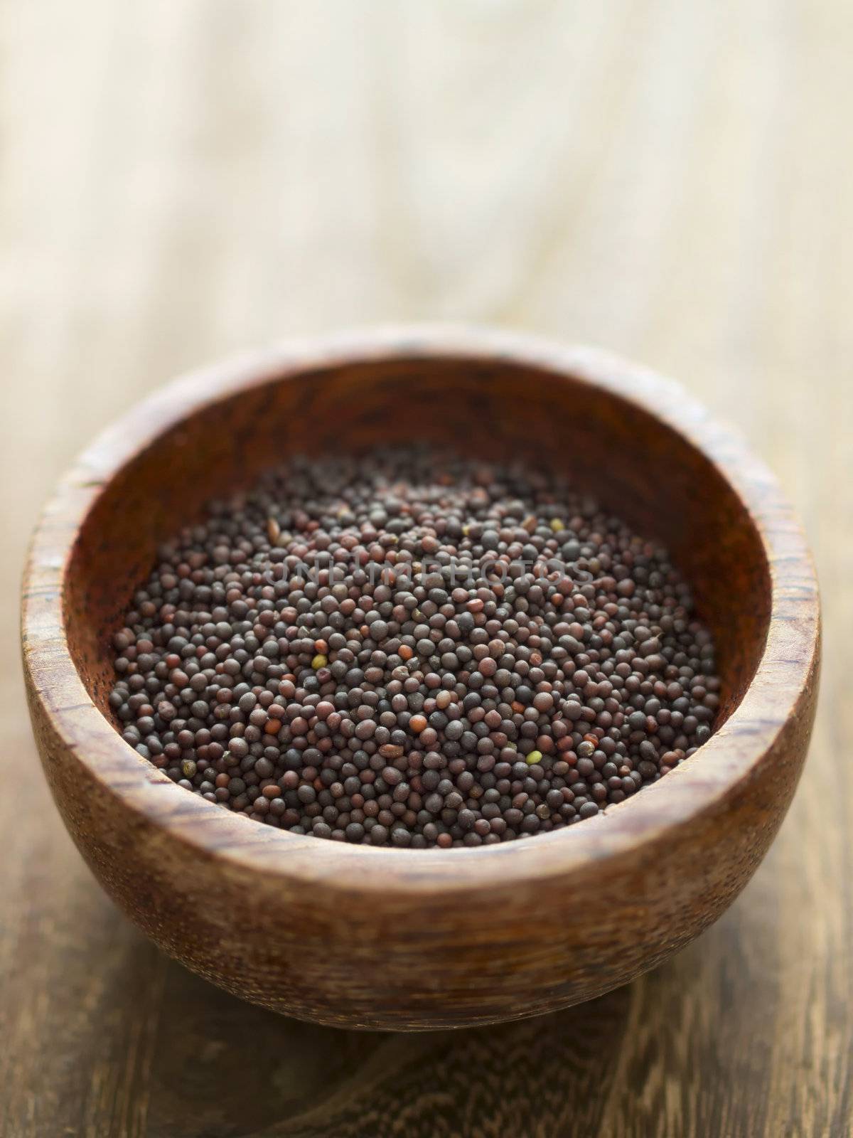 close up of a bowl of black mustard seeds